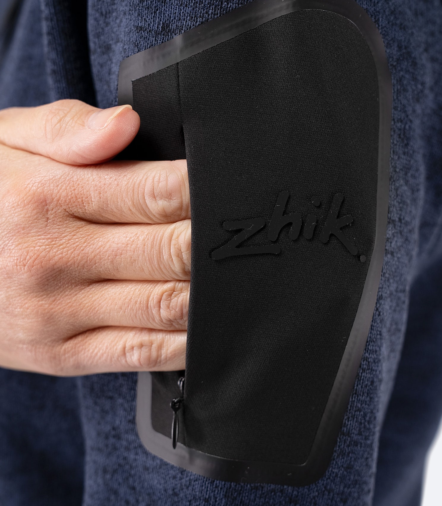 Close-up of zippered arm pocket on Zhik Women’s Knit Fleece Jacket in dark navy marle