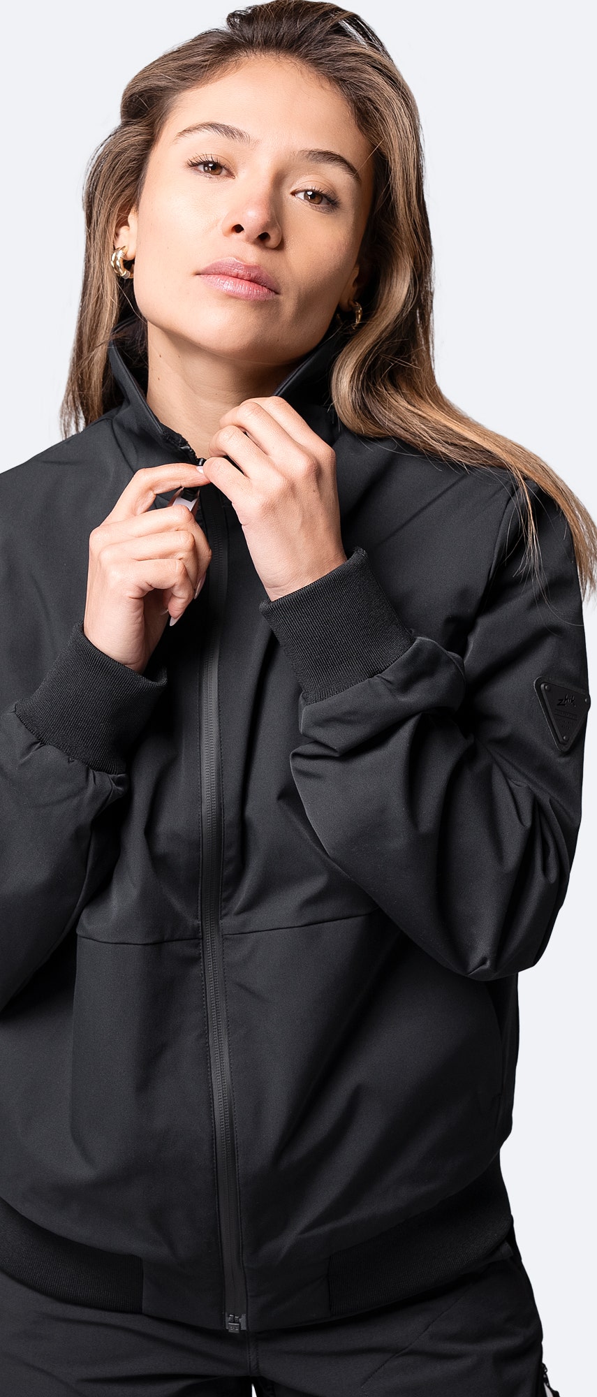Close-up of black Women's Flight Jacket collar and wrist cuffs, featuring fleece lining and smooth twill fabric.
