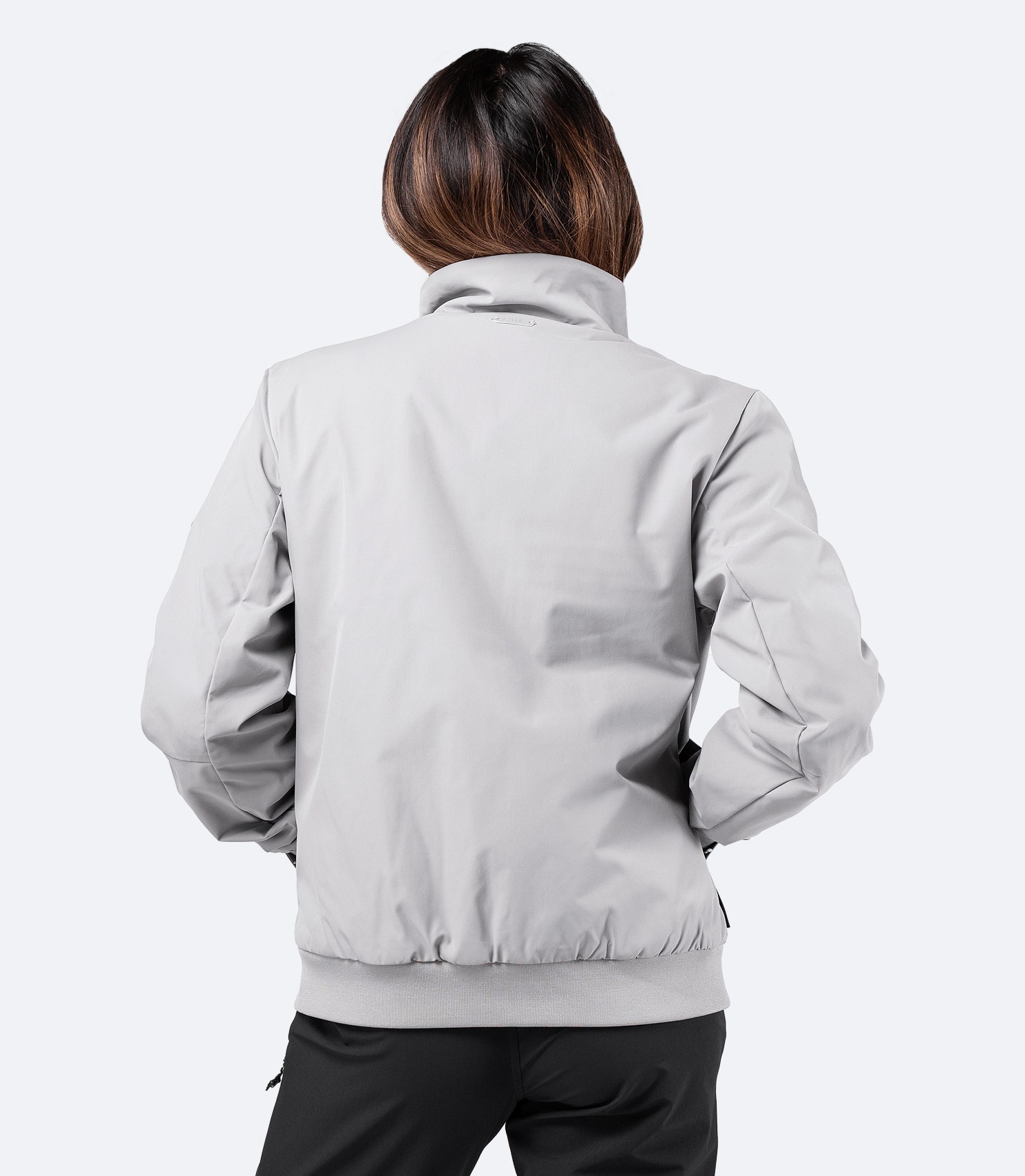Rear view of Zhik Women's Flight Jacket in platinum, highlighting bomber jacket styling and tailored fit.