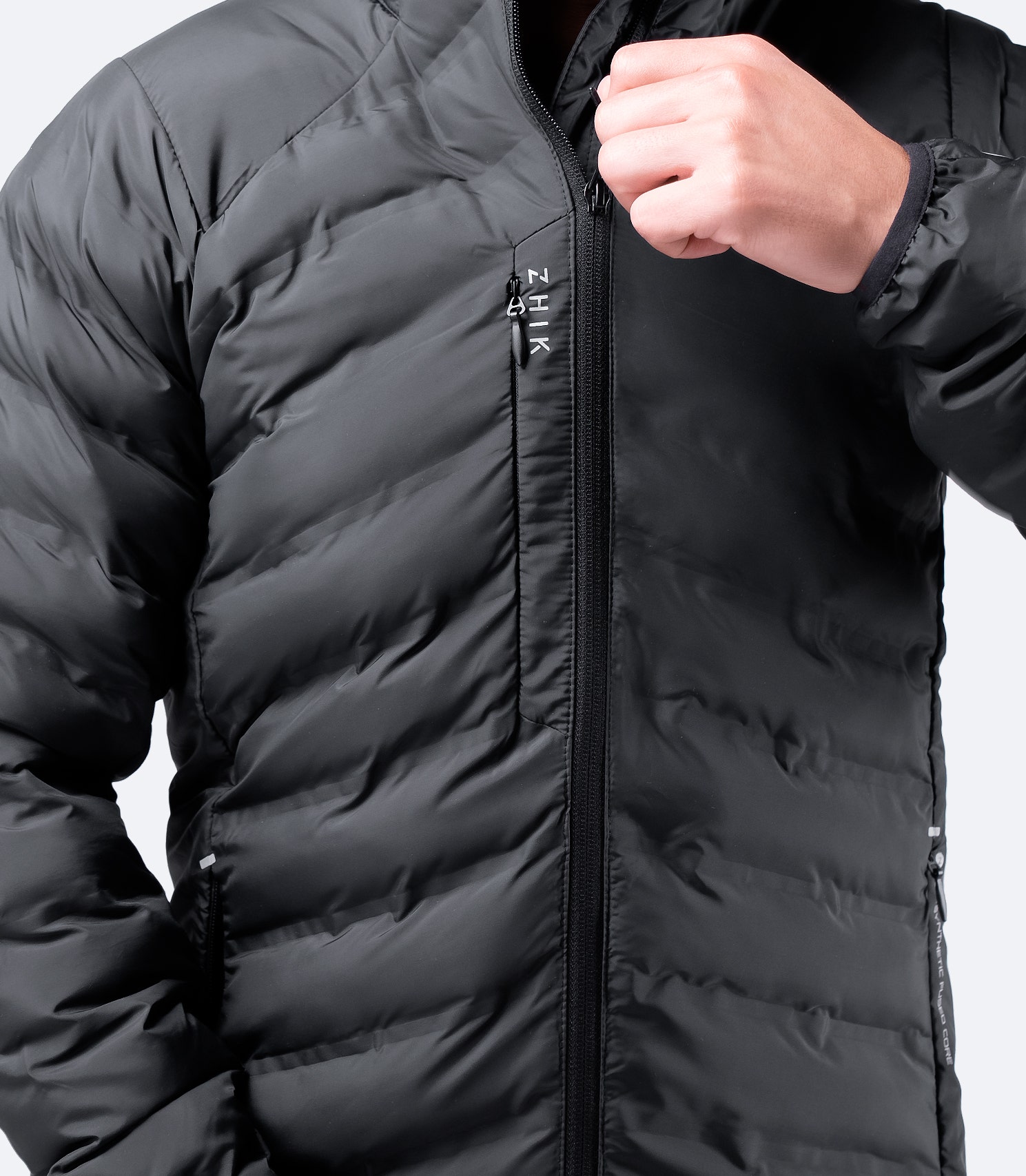 Close-up of zippered chest pocket on Men's Black Zhik Cell™ Insulated Jacket, designed for secure storage.