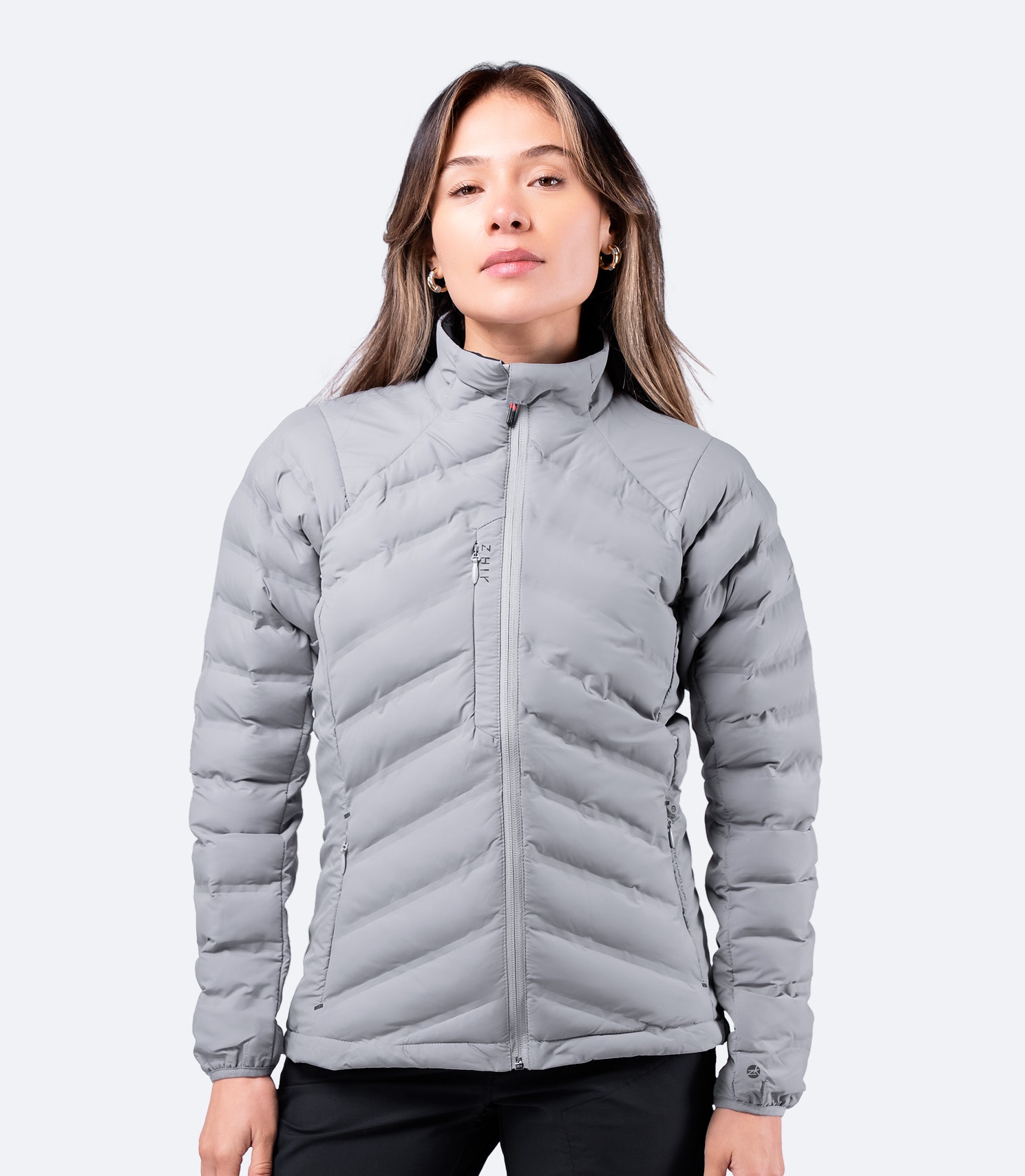 Zhik Women's Platinum Cell™ Insulated Jacket worn casually, highlighting modern styling and Repreve® insulation.