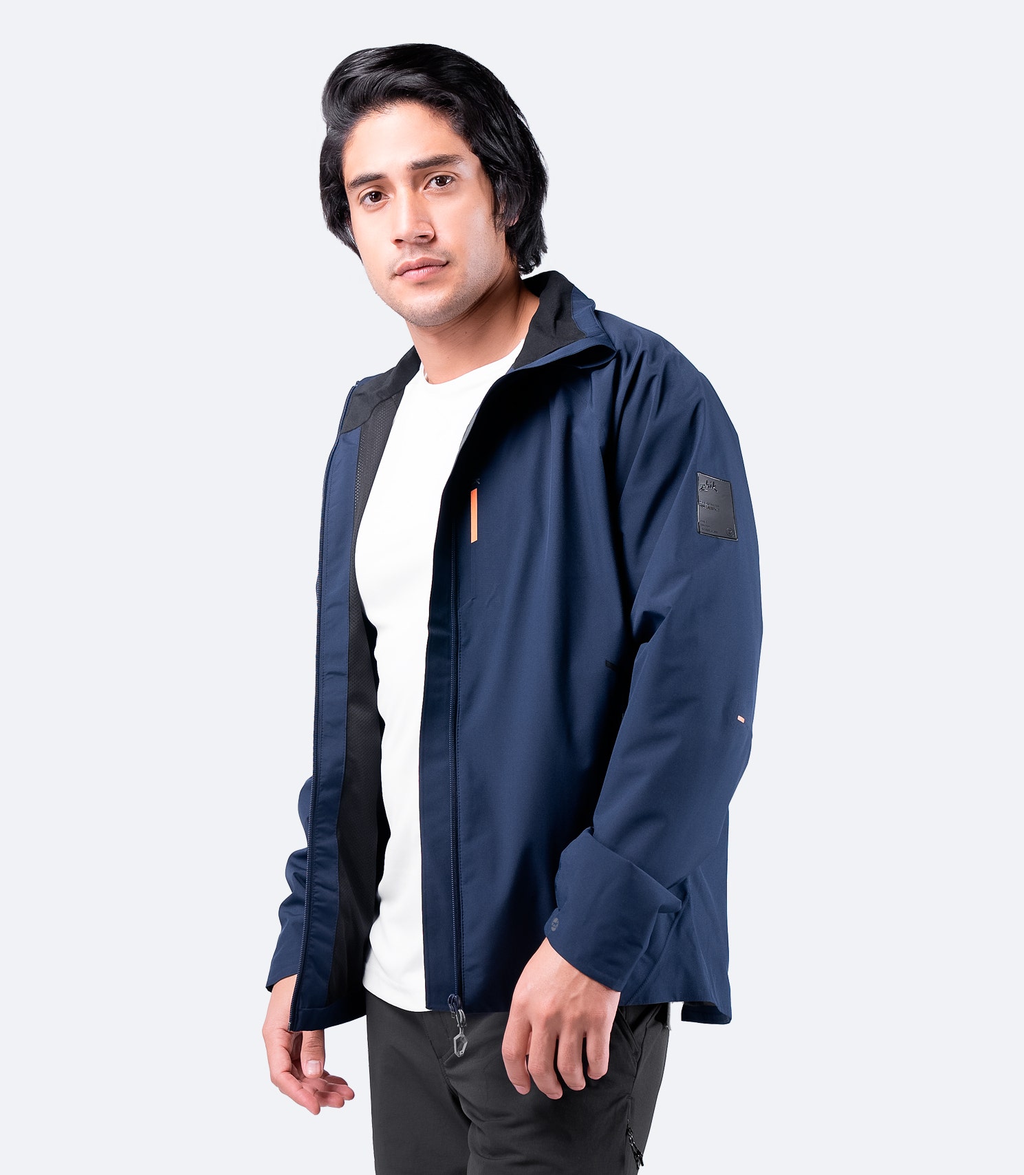 Side view of Zhik Men's INS100™ Jacket in Navy with open zipper, showcasing lightweight, breathable construction and zippered side pockets.