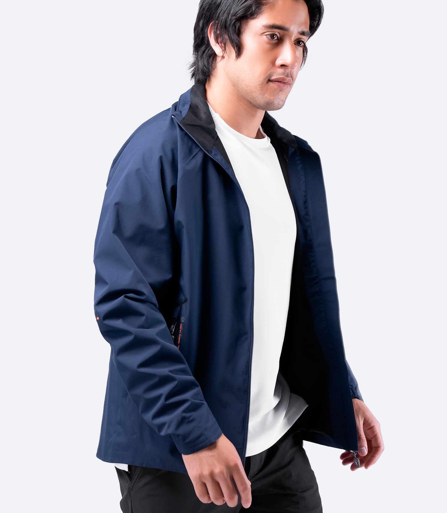 Side view of Zhik Men's INS100™ Jacket in Navy with open zipper, showcasing lightweight, breathable construction and zippered side pockets.