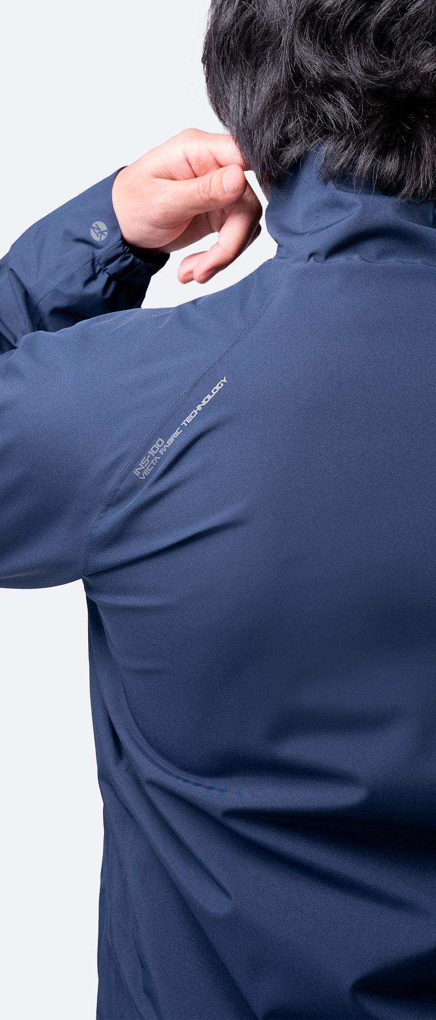 Back view of Zhik Men's INS100™ Jacket in Navy, featuring fully taped seams, sculpted fit, and pre-formed cuffs for freedom of movement.