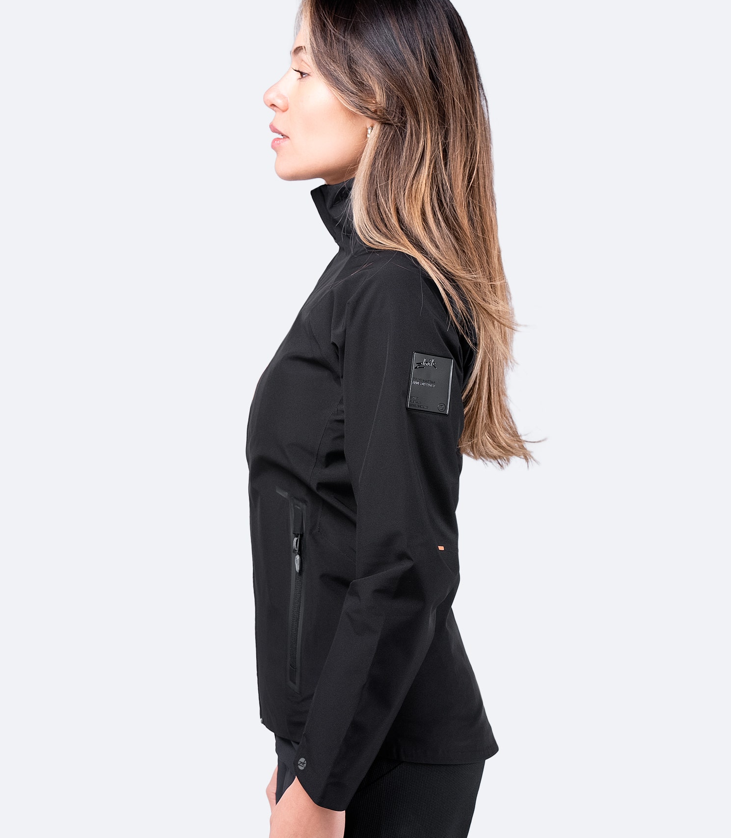 Zhik Women's Black INS100™ Jacket, side view displaying zippered pocket and pre-formed cuffs for enhanced mobility.