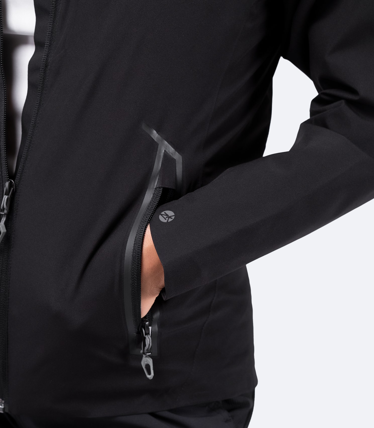 Zippered chest pocket of Women's Black INS100™ Jacket, designed for secure storage with a sleek, low-profile look