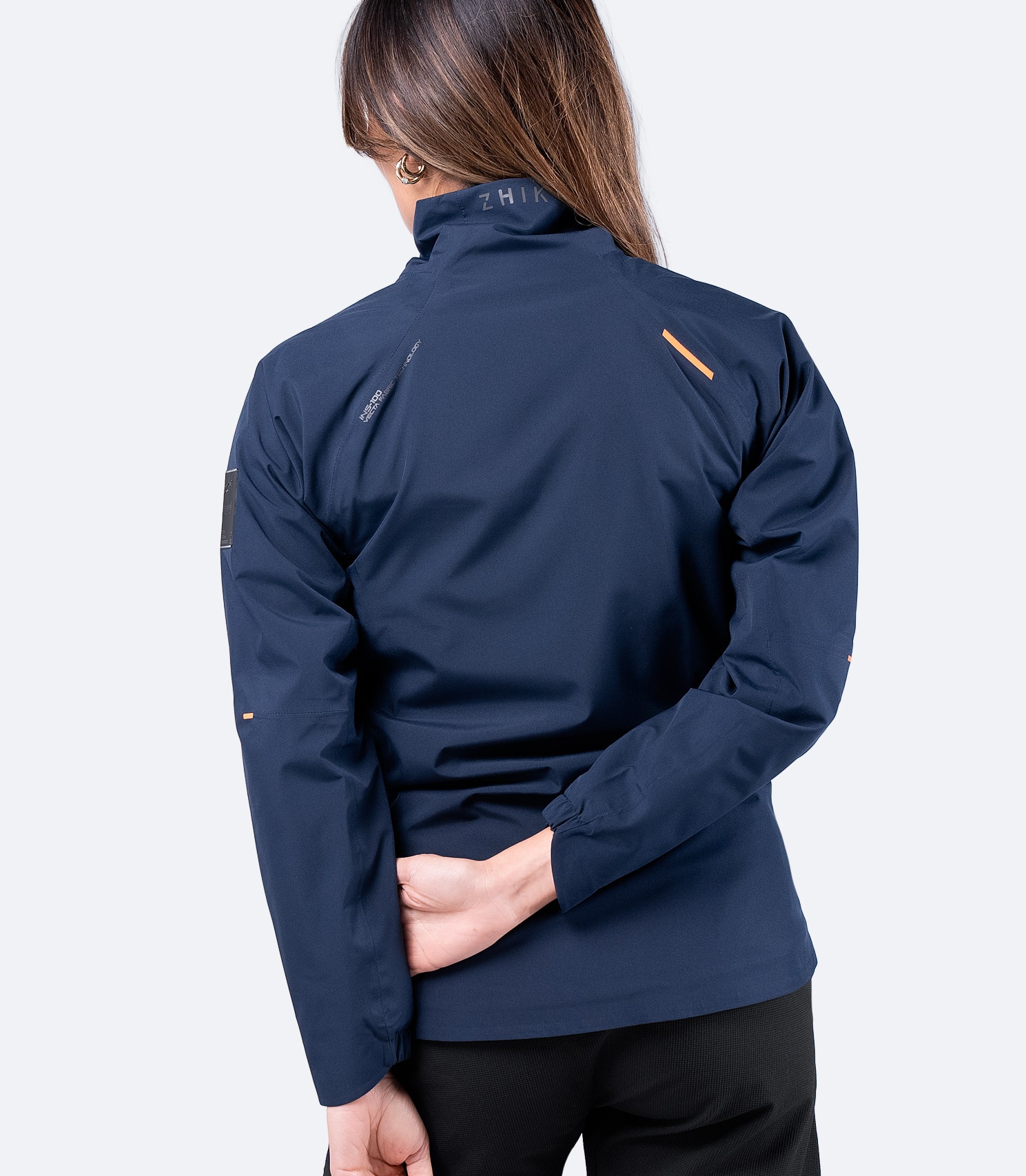 Back view of Zhik Women's Navy INS100™ Jacket, showing sculpted fit, waterproof construction, and reinforced seams for durability.