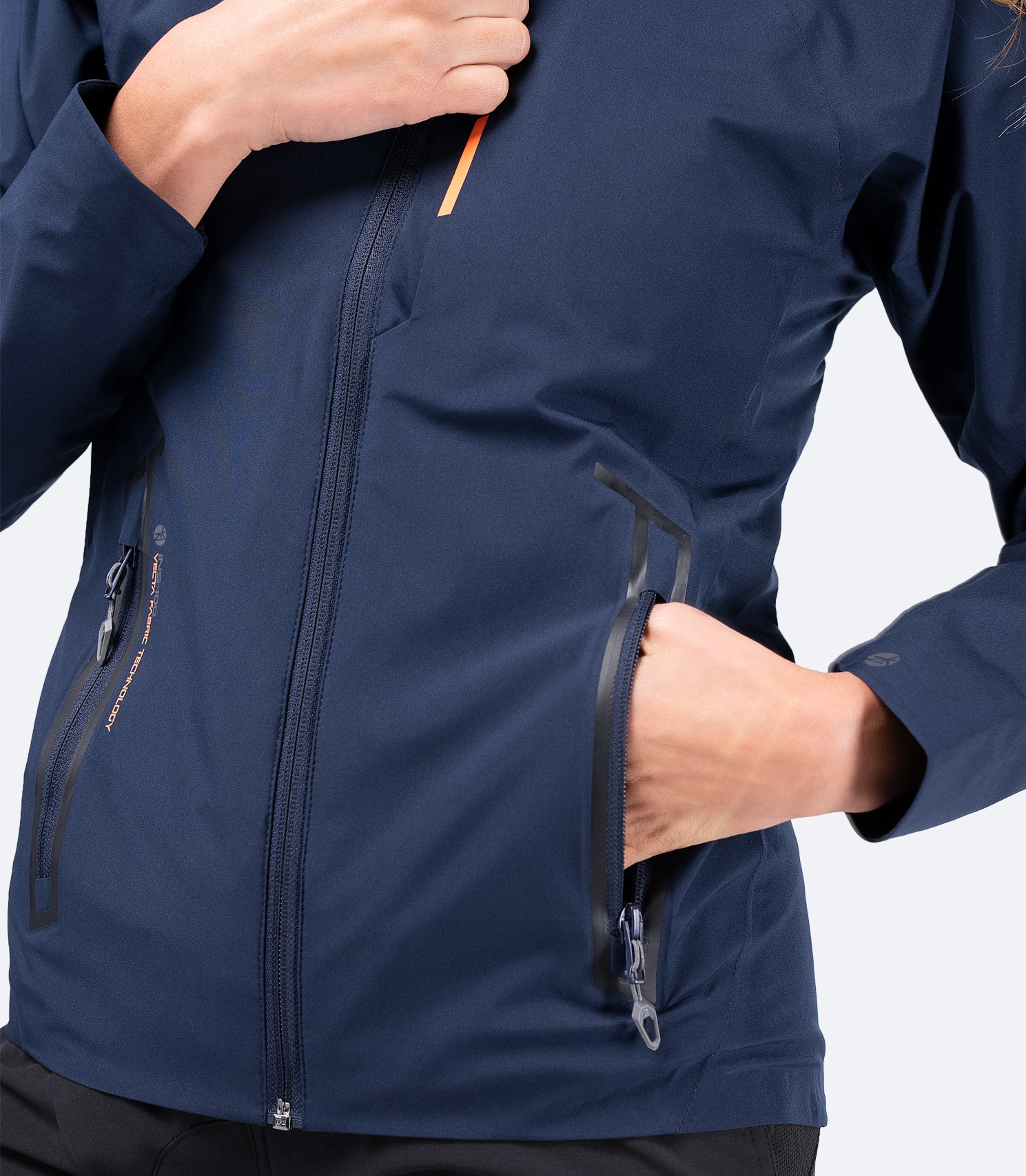 Zippered chest pocket of Women's Navy INS100™ Jacket, designed for secure storage with a low-profile look.