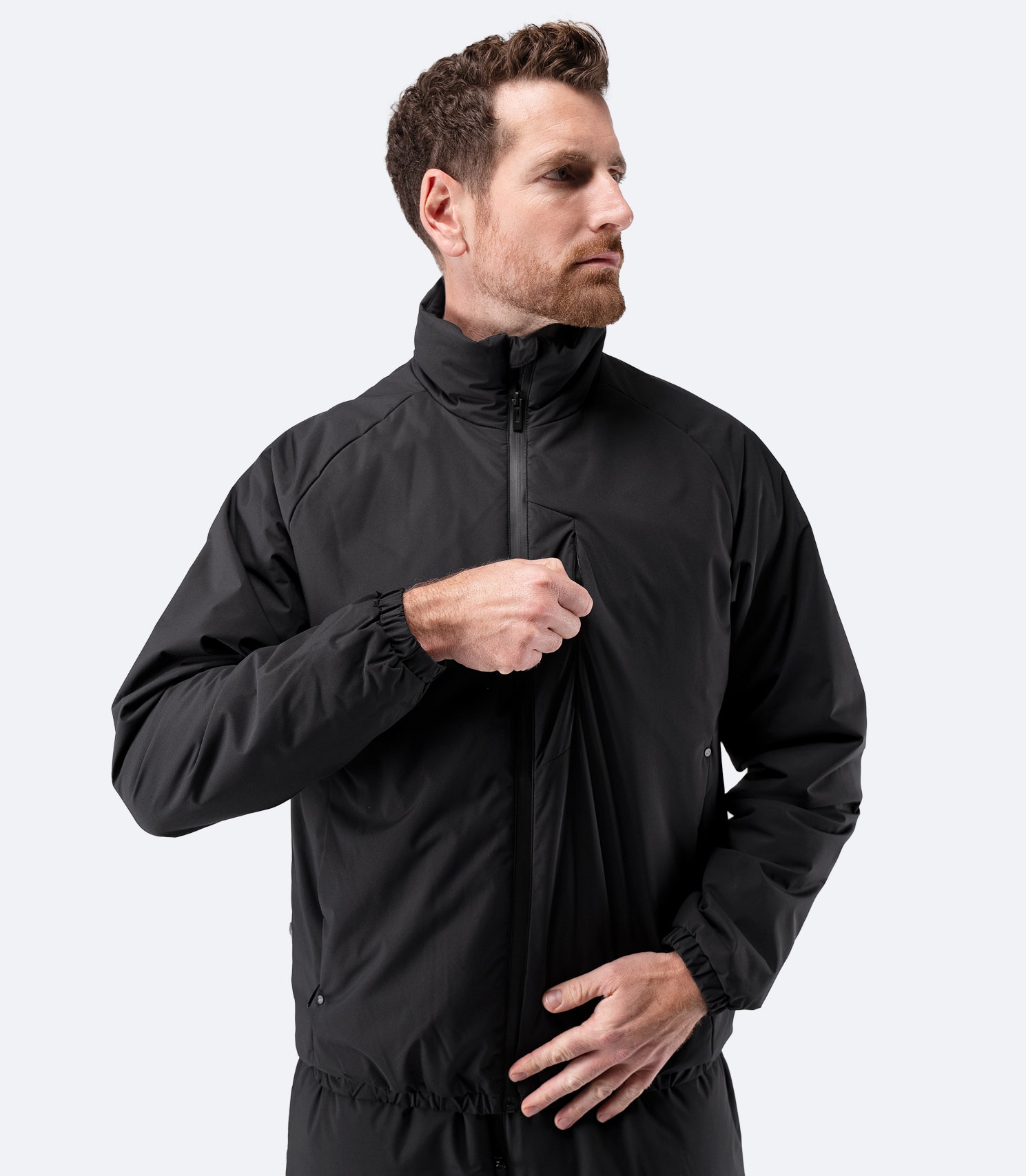 Zhik Men’s Daybreaker Mid-layer Jacket in black, front view with zip partially closed.