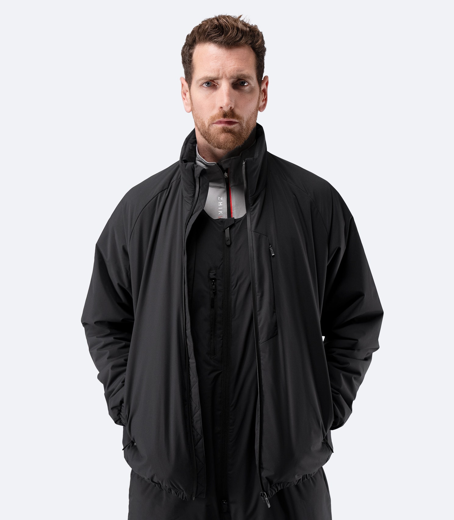 Zhik Men’s Daybreaker Mid-layer Jacket in black, front view with full zip open.