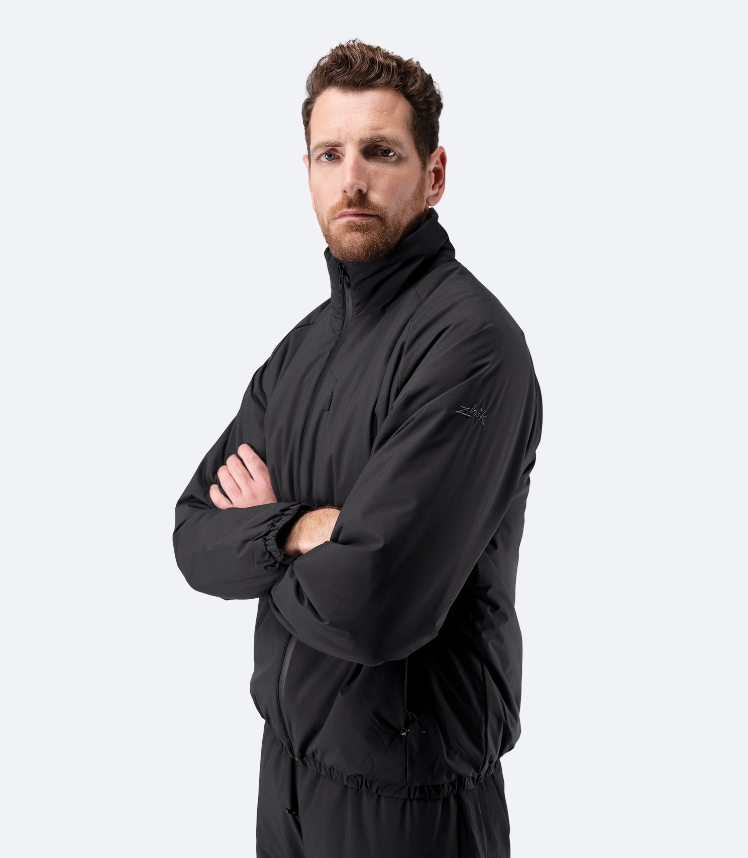 Side profile of Zhik Men’s Daybreaker Mid-layer Jacket in black with relaxed fit
