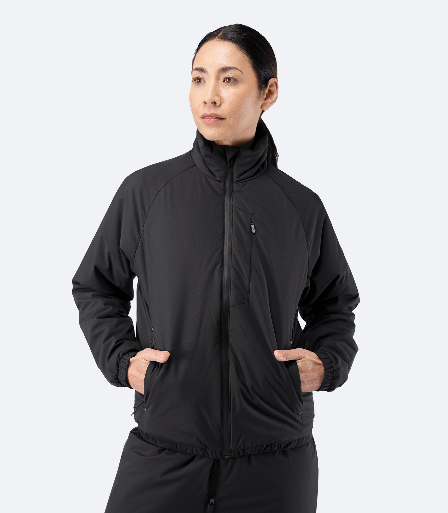 Front view of Zhik Women’s Daybreaker Mid-layer Jacket in black, zipped up with high collar