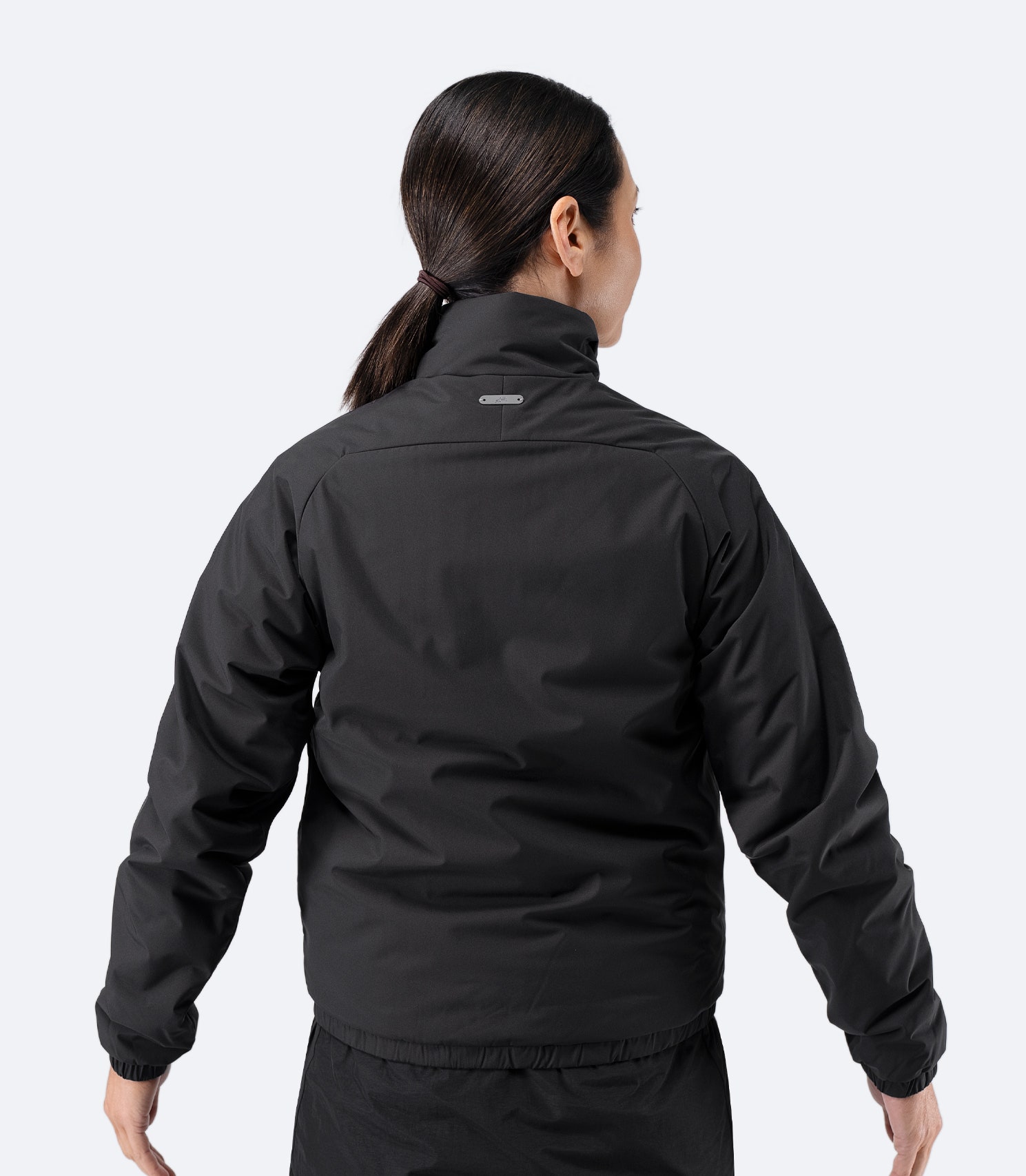 Back view of Zhik Women’s Daybreaker Mid-layer Jacket in black with articulated fit