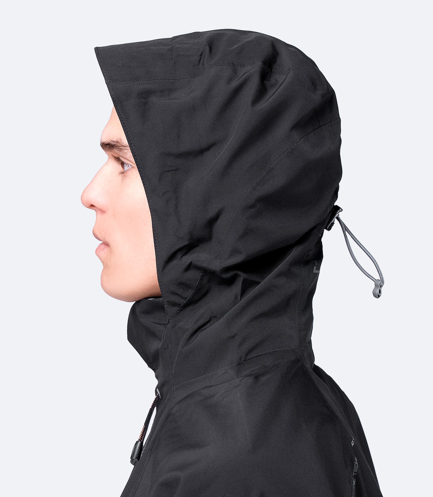 Close-up side view of the hood on Zhik Men's Black INS200 Jacket, showcasing the high collar and adjustable waterproof hood design