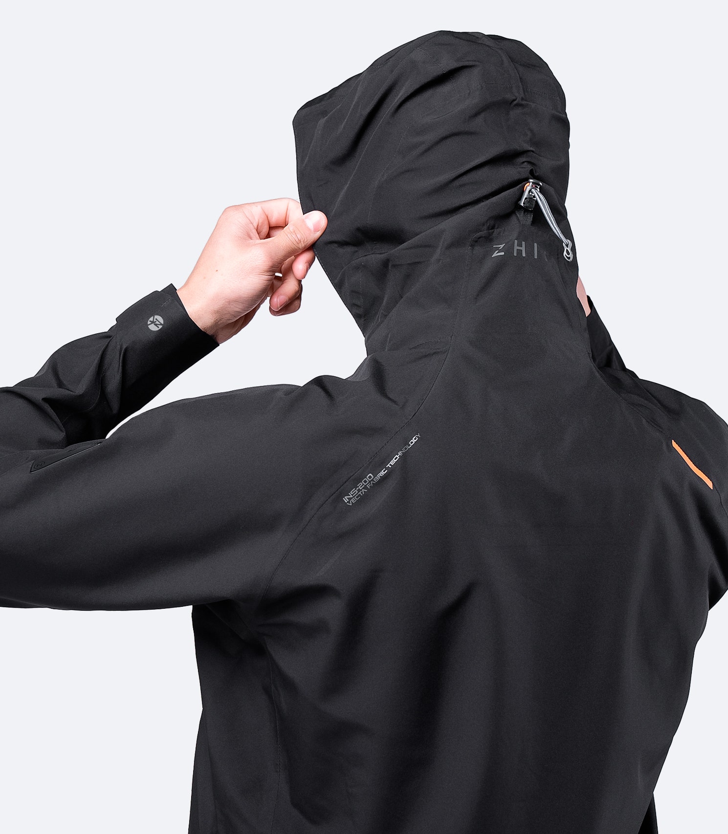 Close-up of the rear view of Zhik Men's Black INS200 Jacket, highlighting the adjustable hood and waterproof seam construction