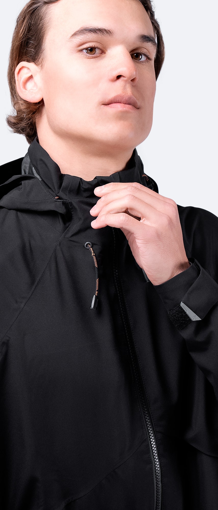 Front view of Zhik Men's INS200 Jacket in Black with hood down and zipper up, showcasing a sleek fit and waterproof design