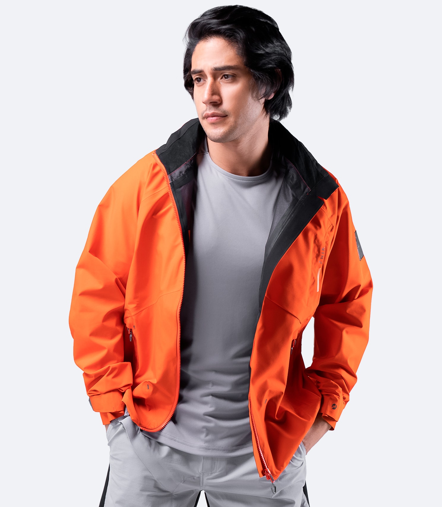 Front view of Zhik Men's Flame Red INS200 Jacket worn casually with zipper open, showcasing breathable, waterproof design and relaxed fit