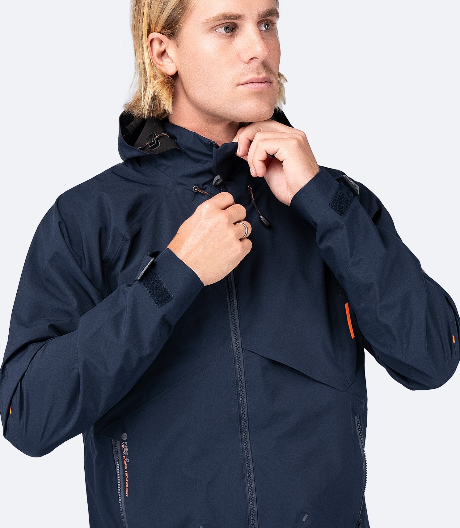 Front view of Zhik Men's INS200 Jacket in Midnight Blue with hood down and zipper up, showcasing a sleek fit and waterproof design