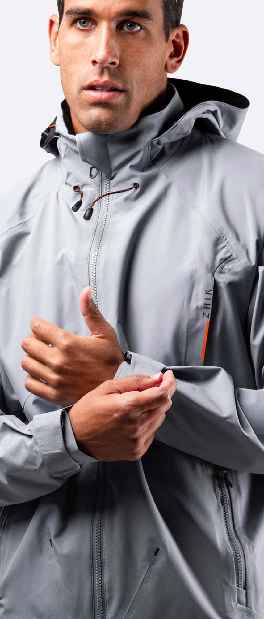 Front view of Zhik Men's INS200 Jacket in Platinum with hood down and zipper up, showcasing a sleek fit and waterproof design