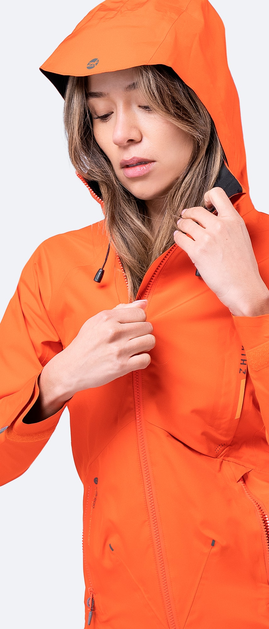 Front view of Zhik Women's Flame Red INS200 Jacket with hood up and zip fully closed, providing full waterproof protection