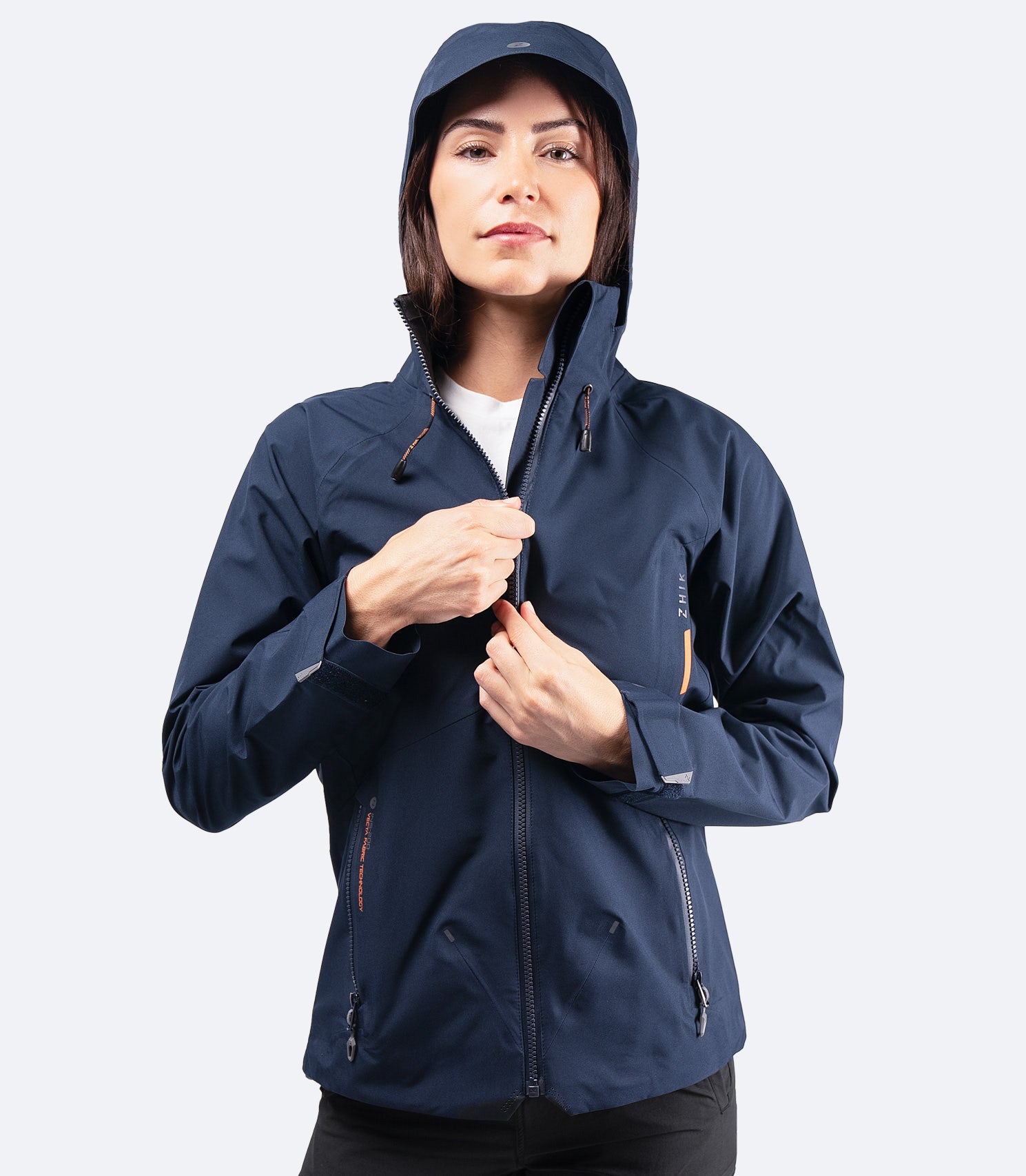 Front view of Zhik Women's Midnight Blue INS200 Jacket with hood up and zip fully closed, providing full waterproof protection