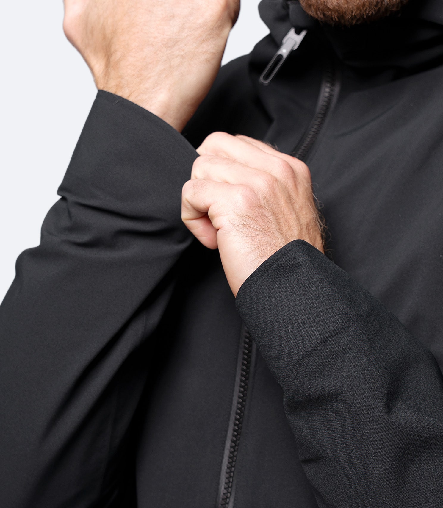 Close-up of sleeve on Zhik Men's Black INS300 Jacket, with adjustable wrist tab for spray protection