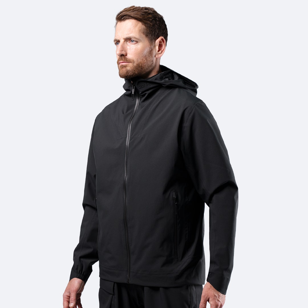 Zhik Men's INS300 Inshore Jacket in Black on male model, front view of lightweight waterproof shell