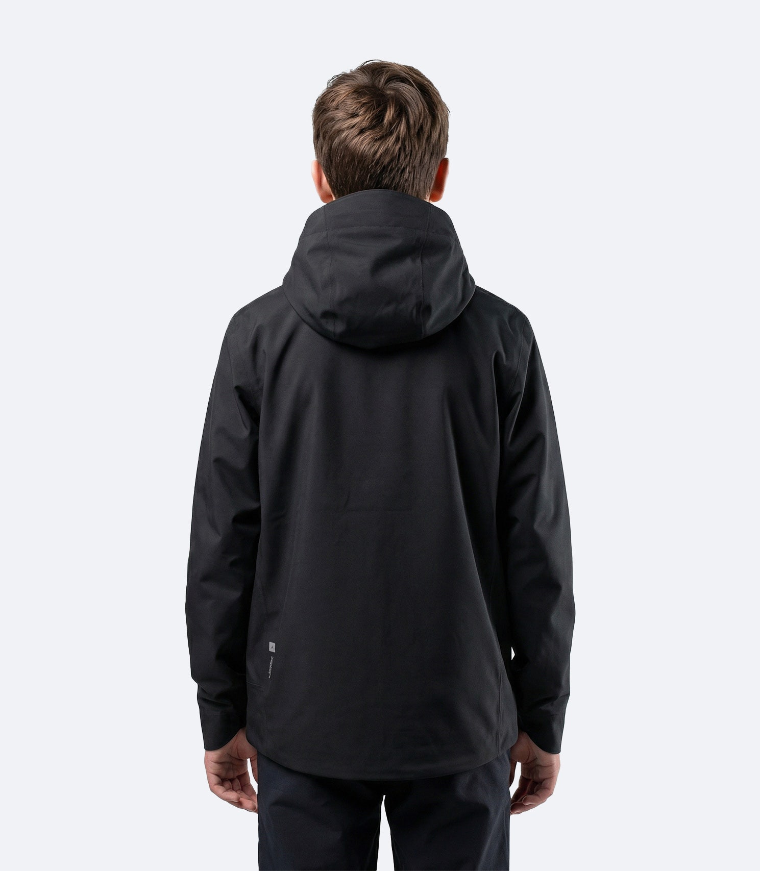 Rear view of Zhik Youth INS300 Inshore Active Jacket in black with clean back panel for team branding