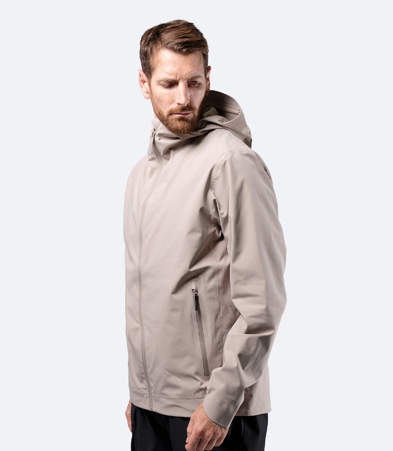 Zhik Men's INS300 Inshore Jacket in Stone on male model, side view of lightweight waterproof shell