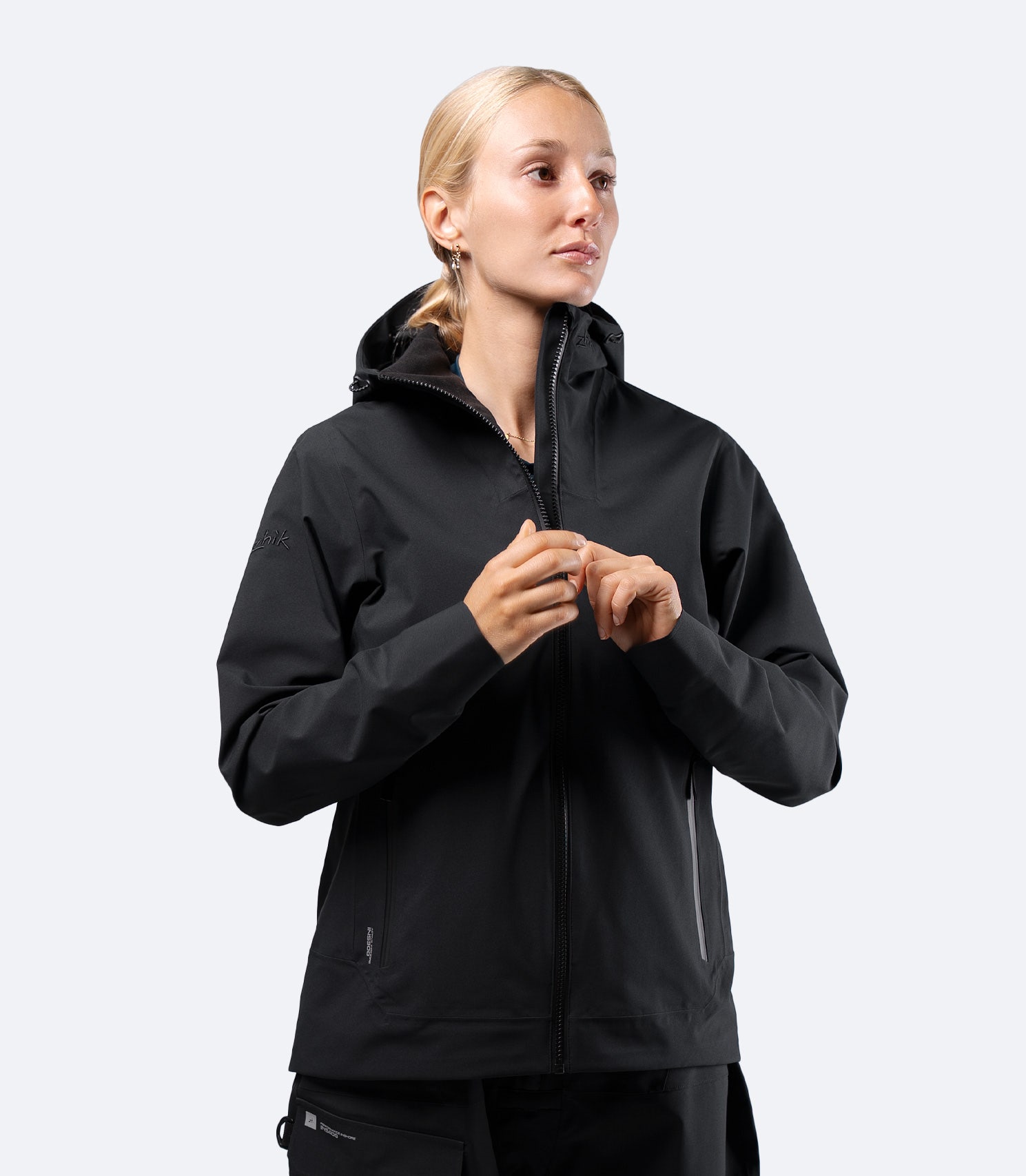 Zhik women's INS300 inshore jacket in Black, front view on female model with hood down showing comfortable jacket fit