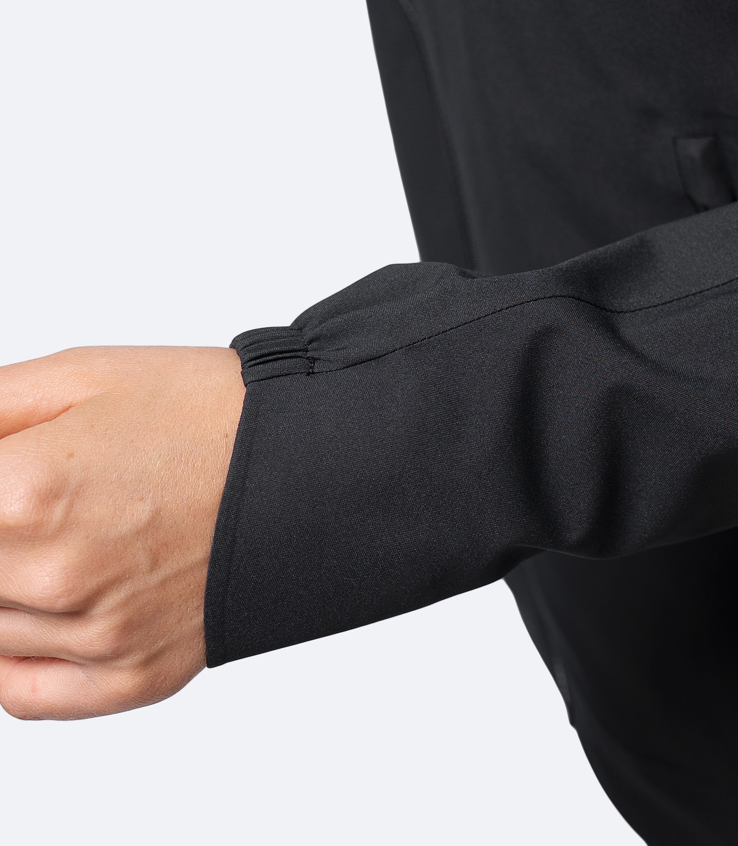 Close-up of Black Zhik women's INS300 jacket wrist showing adjustable cuff and smooth taffeta-lined sleeve