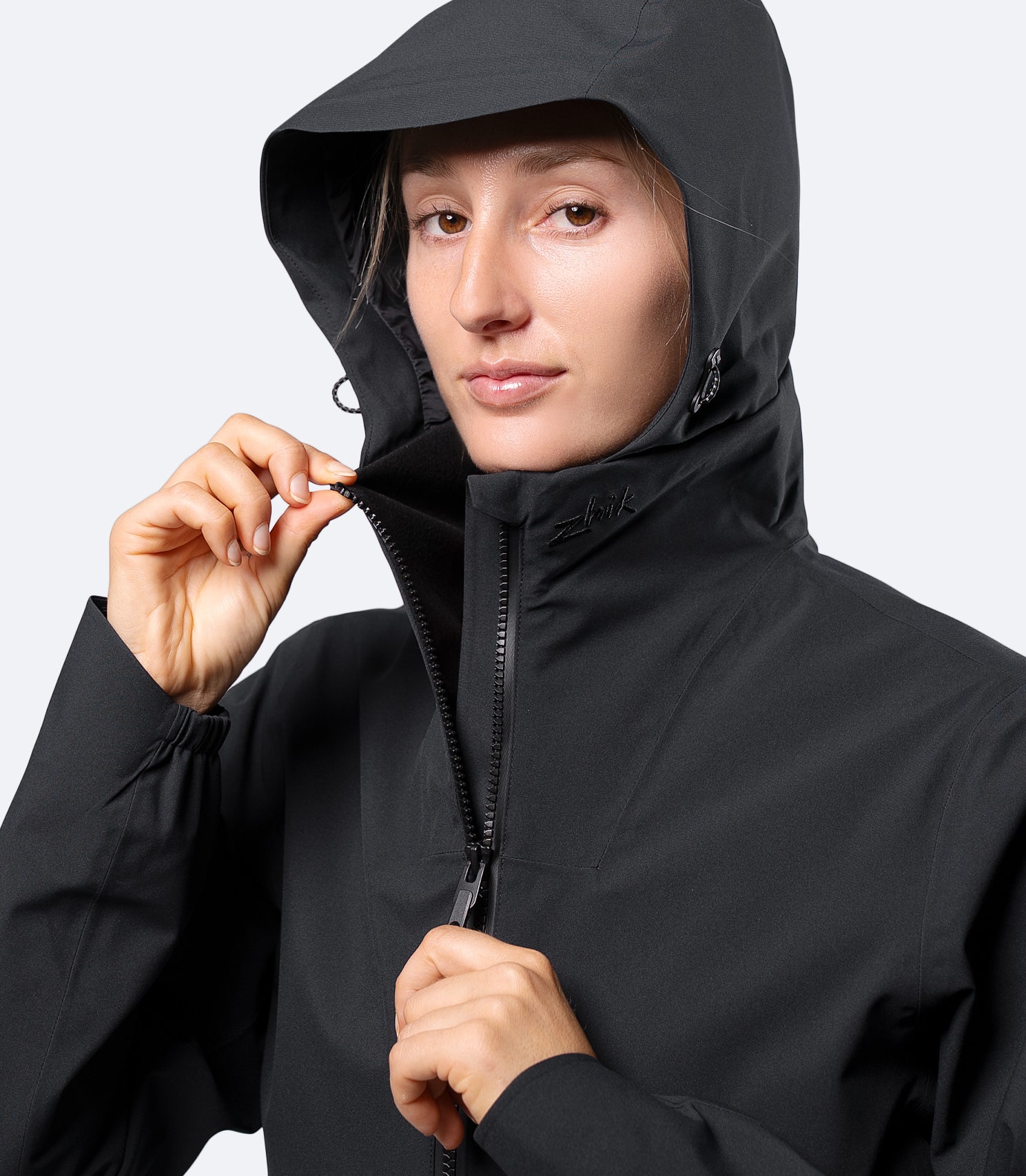 Close-up of Black Zhik women's INS300 jacket hood and front zipper, highlighting waterproof zip and chin guard