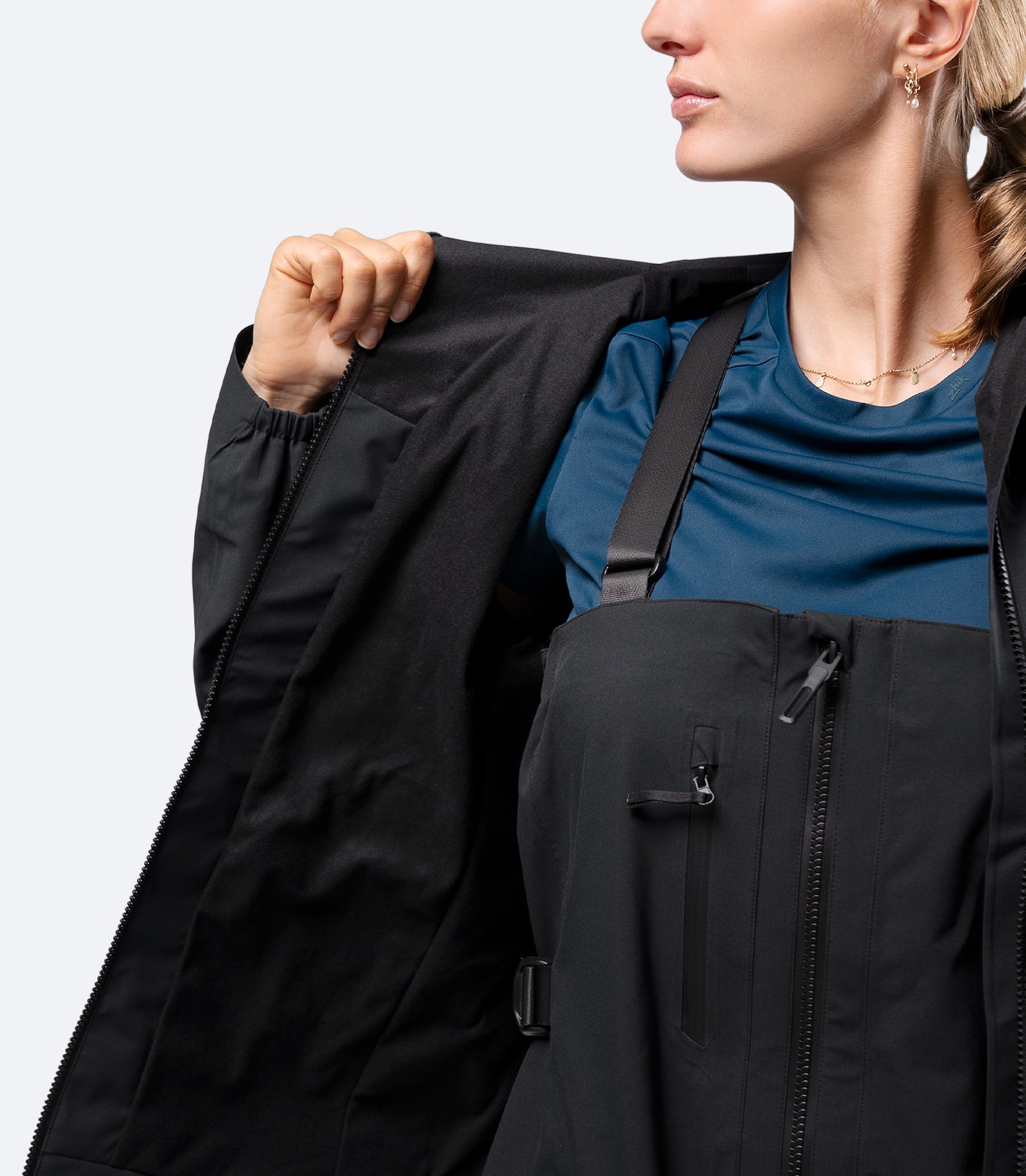 Interior close-up of Zhik women's INS300 jacket in Black, showing micro-fleece torso lining for added warmth