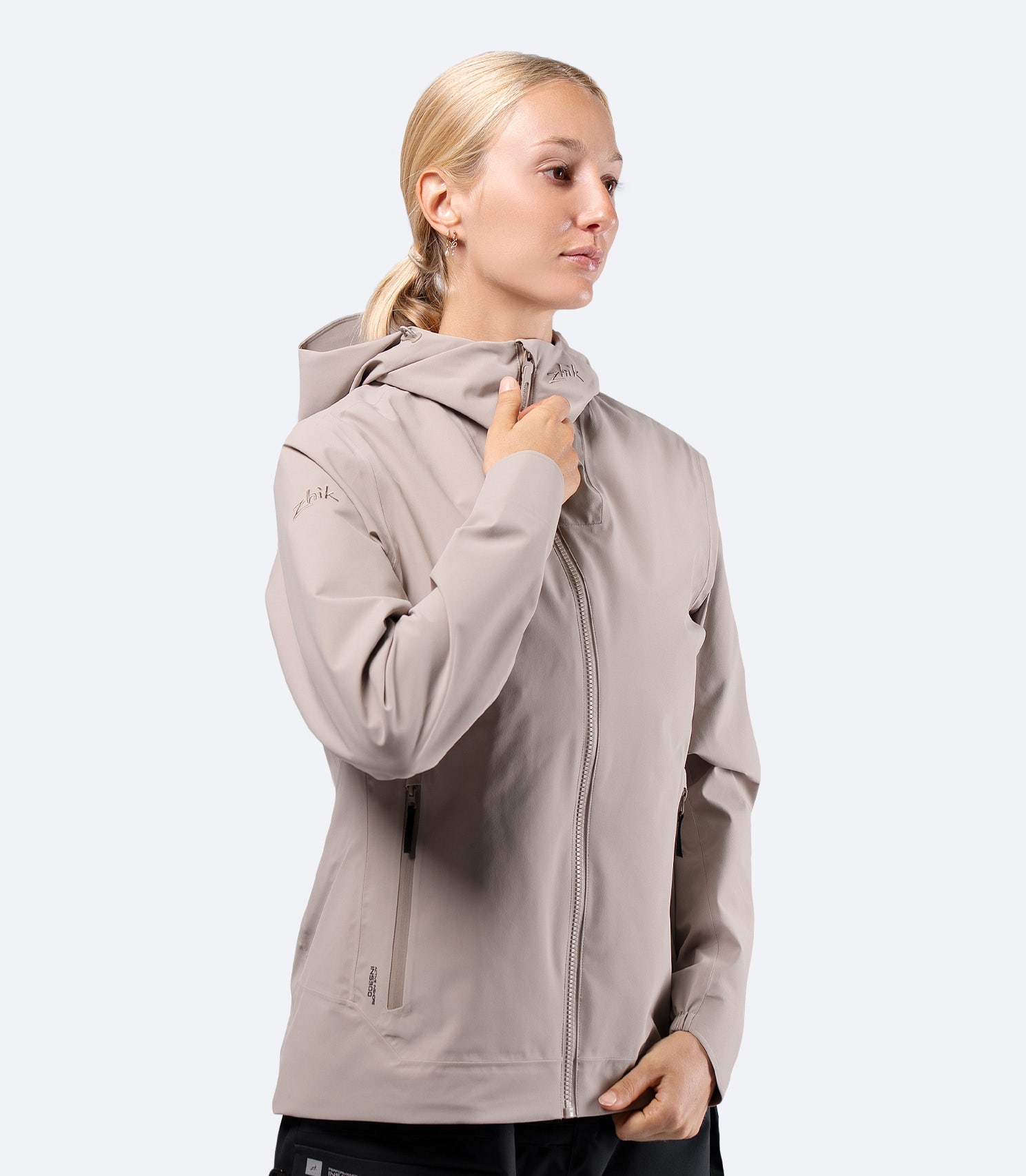 Front view of Zhik INS300 Women's Inshore Active Jacket in Stone on model, hood down with clean styling for everyday wear