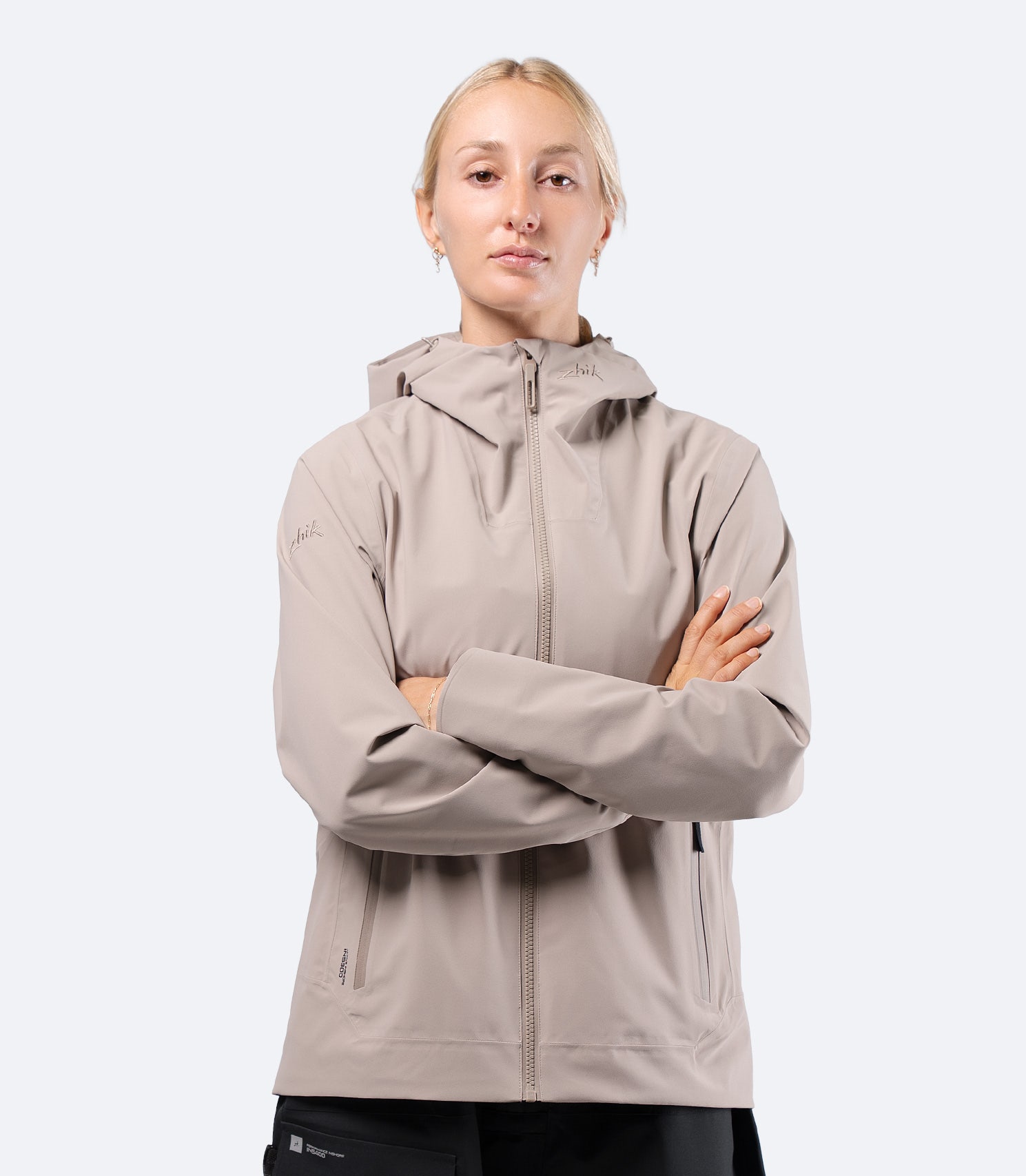 Front view of Zhik INS300 Inshore Women's Active Jacket in Stone, hood down and zip fully closed for a clean, active fit
