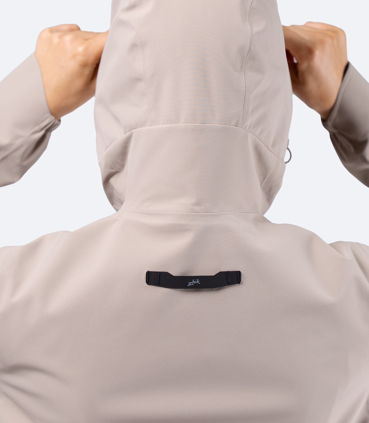 Back close-up of Zhik INS300 Women's Inshore Active Jacket in Stone, showing hood shaping and Hyperlon hang loop for drying