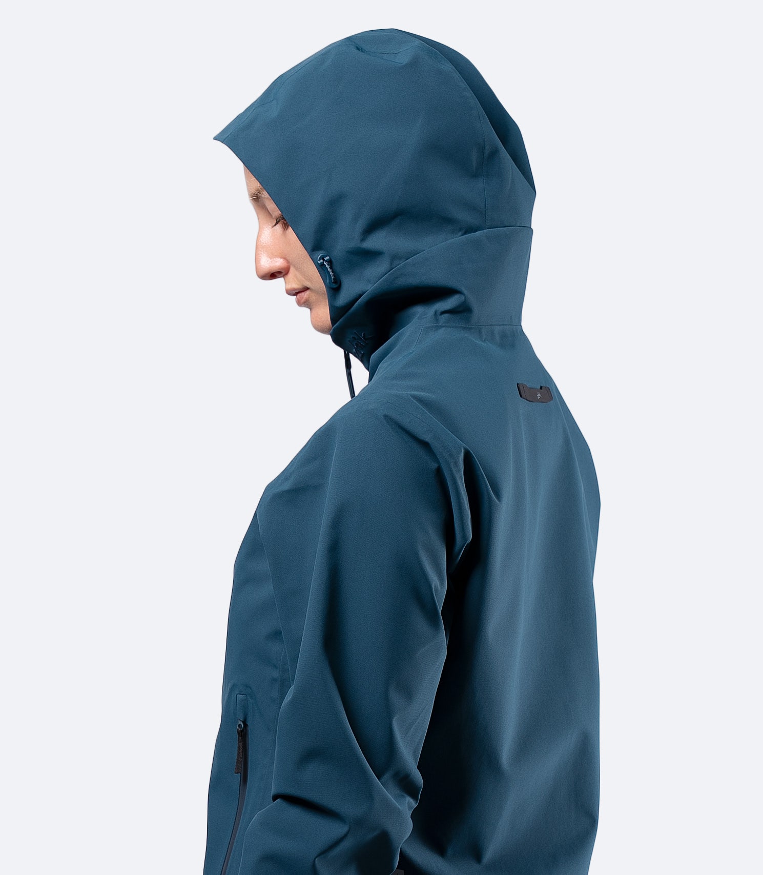 Upper body side view of Zhik INS300 Women's Inshore Active Jacket in Deep Teal, hood up and breathable 2-layer shell visible