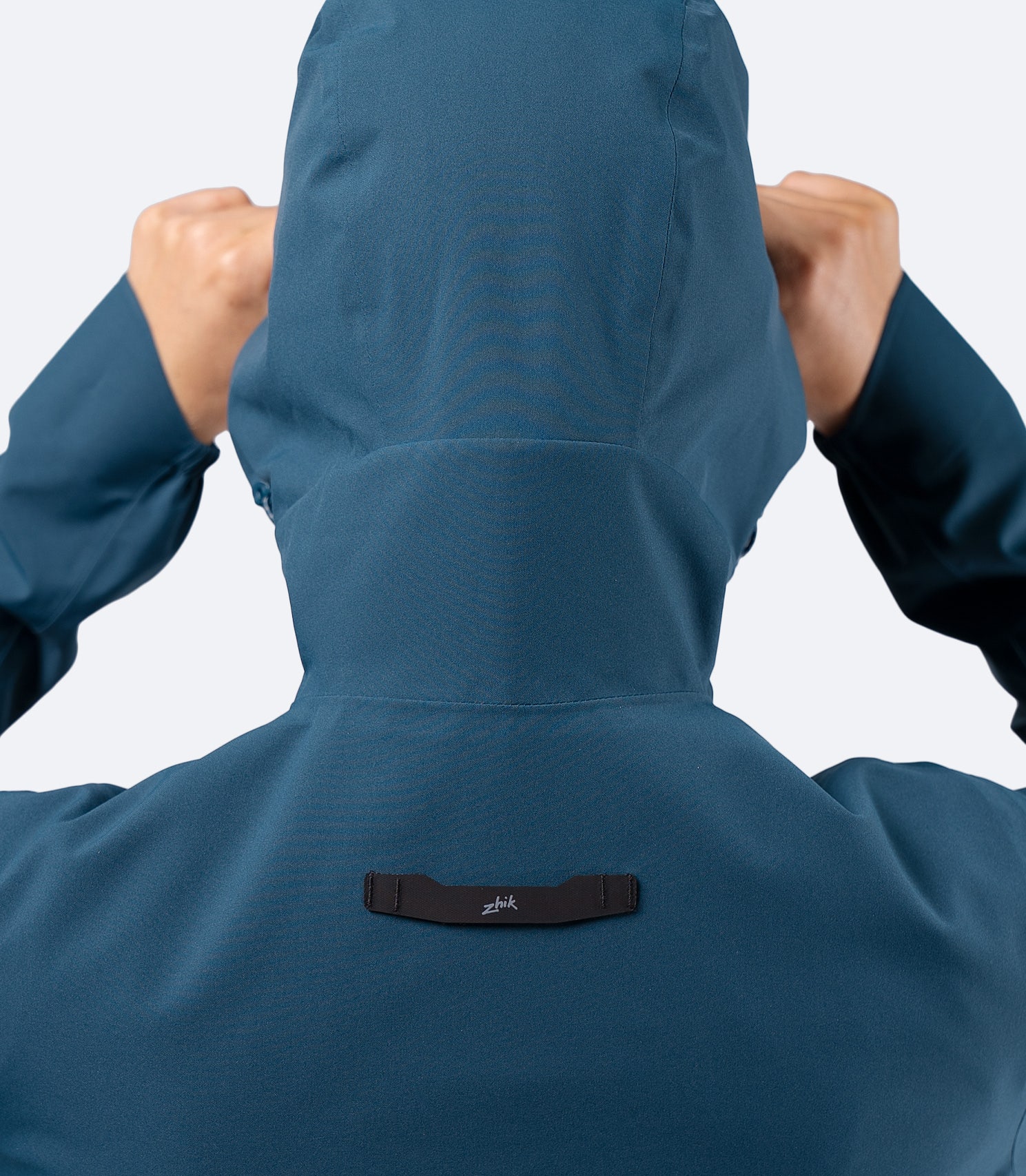 Back close-up of Zhik INS300 Women's Inshore Active Jacket in Deep Teal, showing shaped hood and Hyperlon hang loop