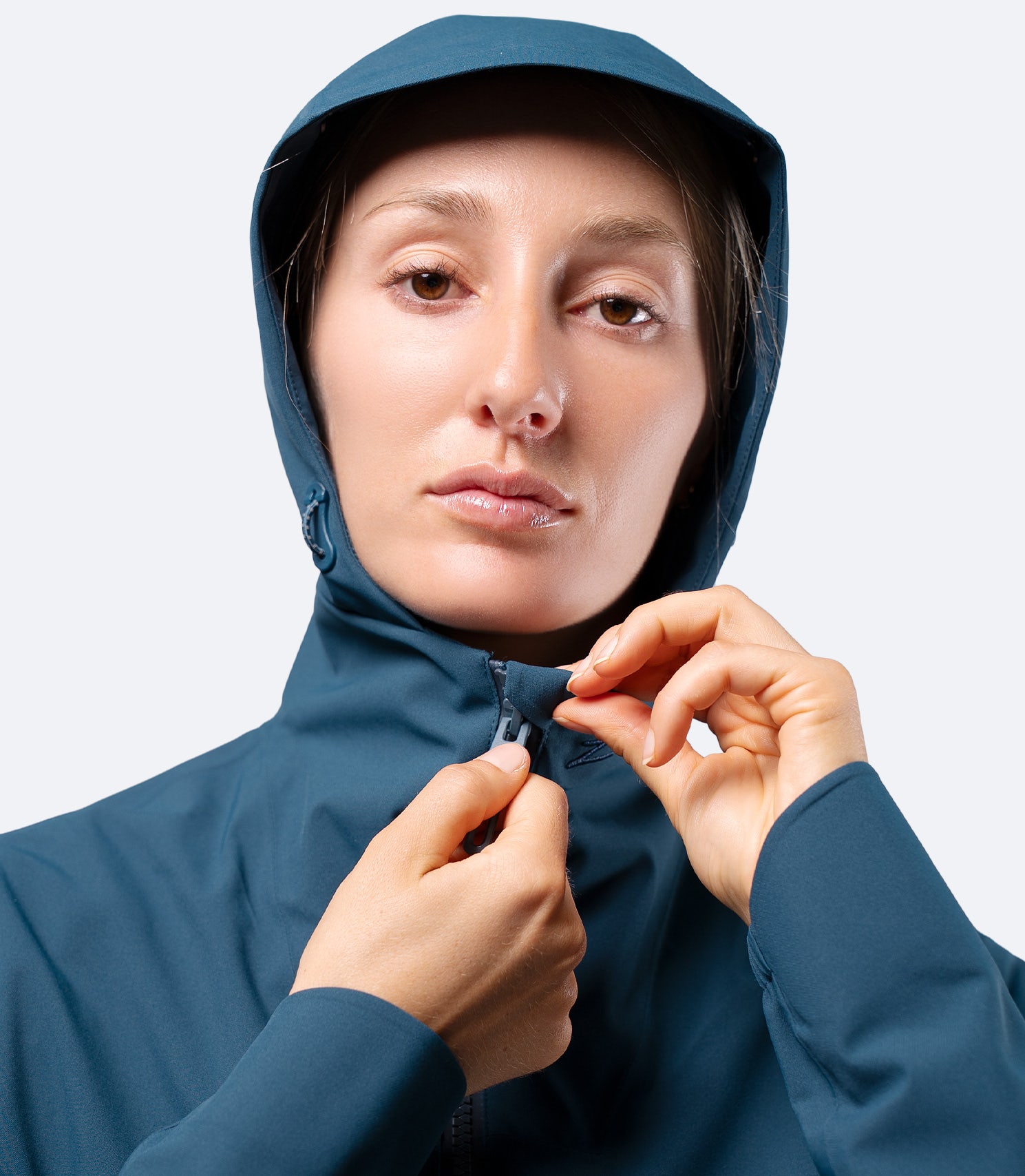 Close-up of Zhik INS300 Women's Inshore Active Jacket in Deep Teal, hood up with front zip to the top for added weather protection