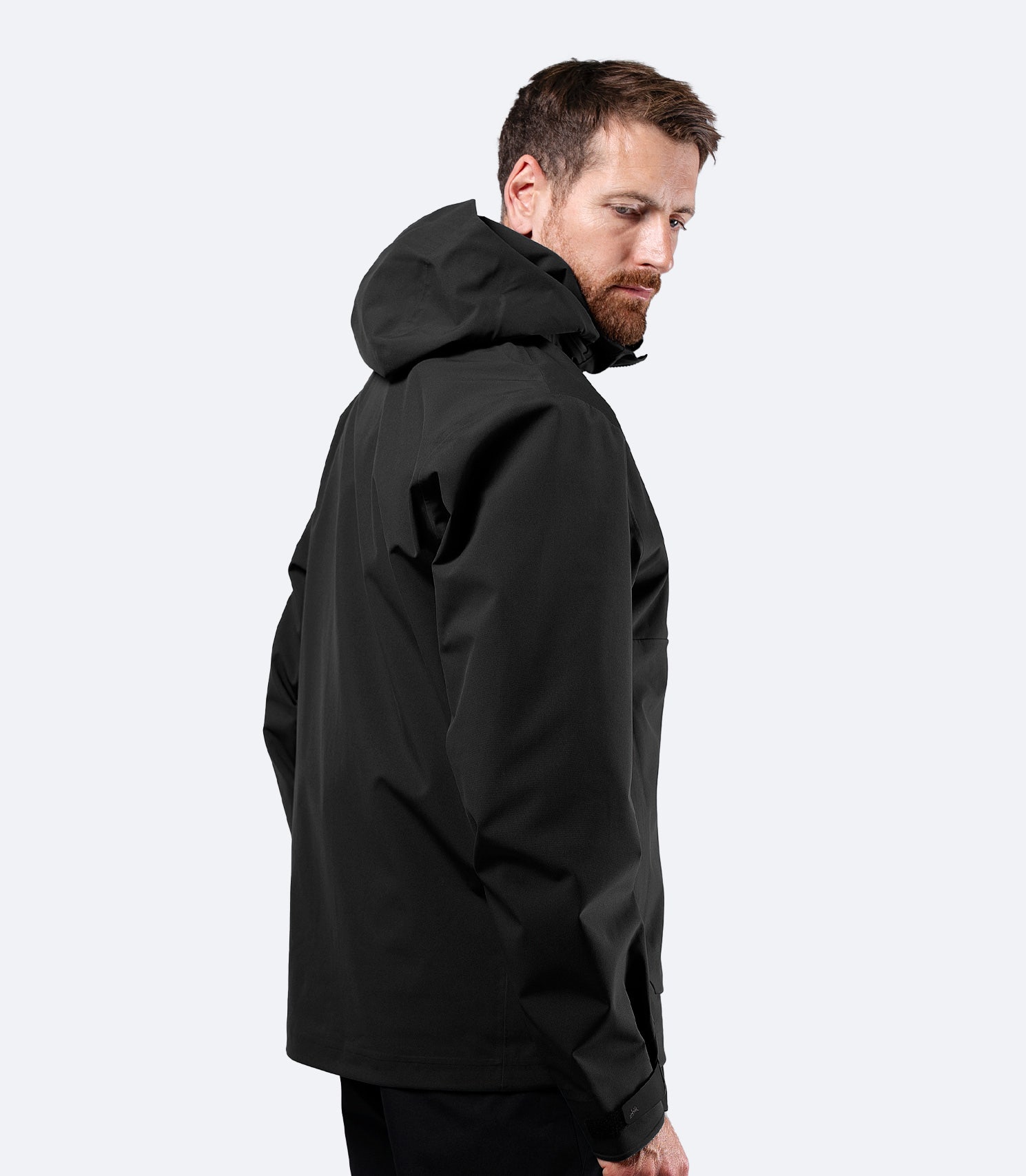 Zhik Men's Black INS400 inshore jacket side view with hood down, articulating sleeves for unrestricted movement