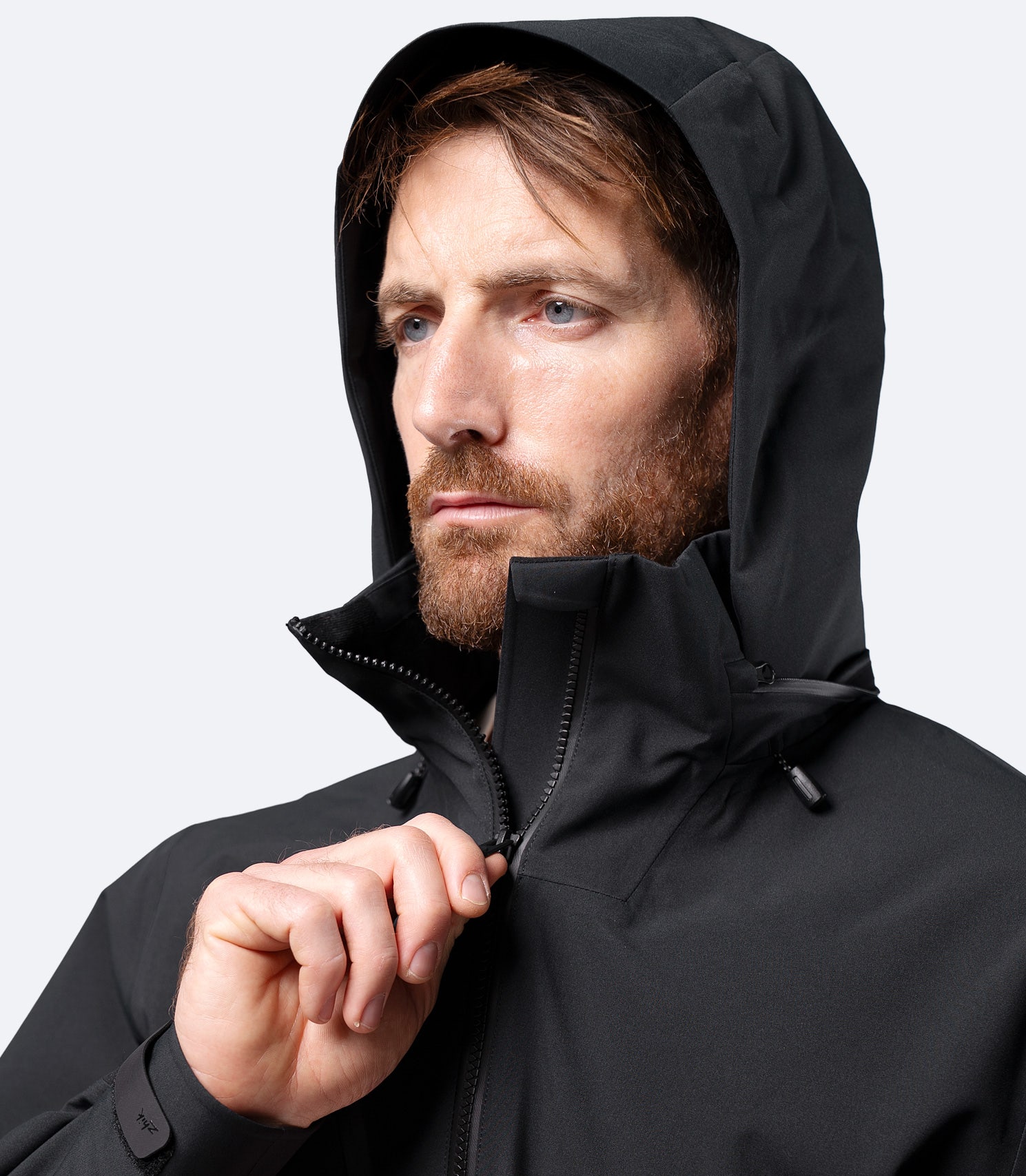 Front close-up of Zhik Men's Black INS400 inshore jacket with hood up and thermal-lined inner collar