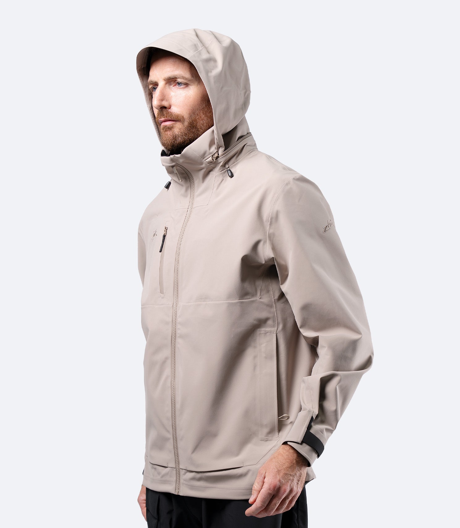 Zhik Men's INS400 inshore jacket in Stone with hood up, streamlined sports cut for active inshore sailing