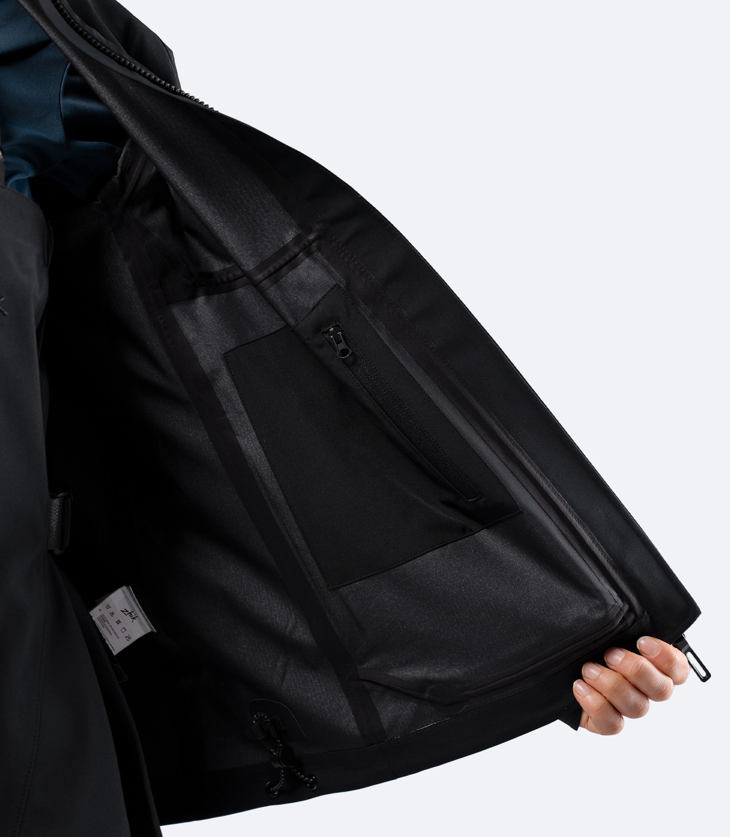 Interior of Zhik Women's INS400 jacket in Black, showing Internal zip pocket with stretch storage bag