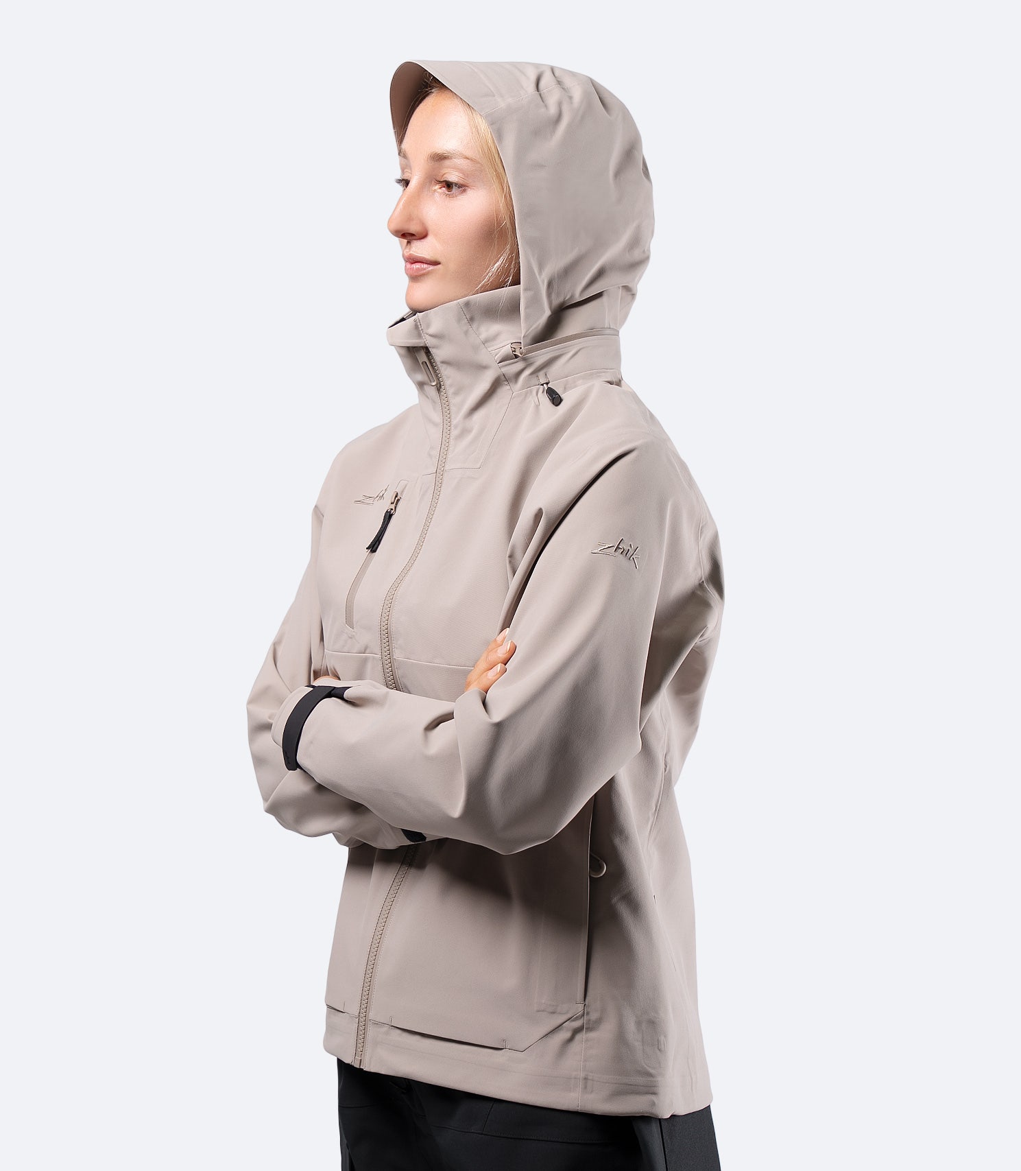 Zhik Women's INS400 inshore jacket in Stone on female model, hood up, front view for active sailing