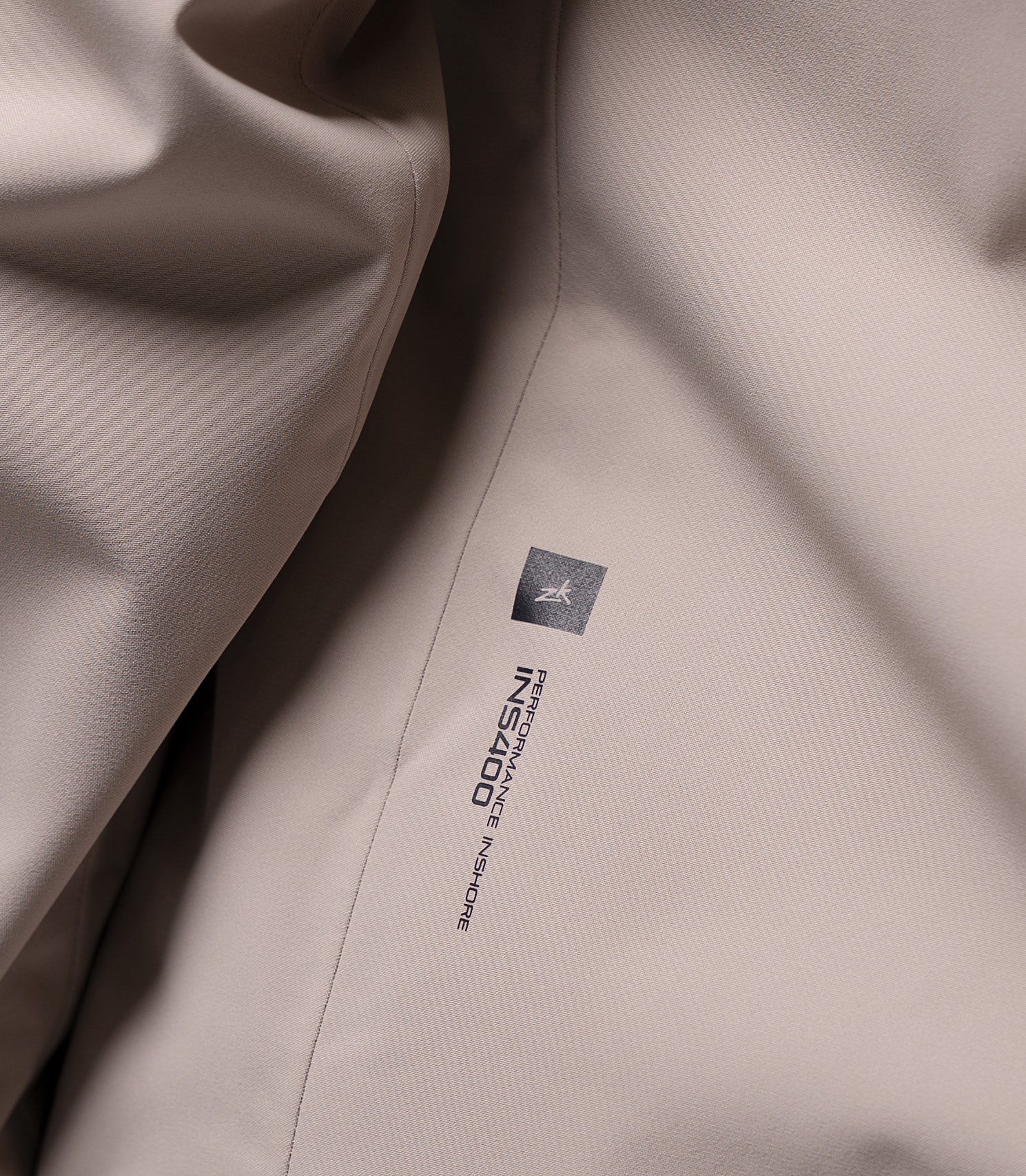 INS400 Performance Inshore logo detail on Zhik Women's Stone inshore jacket, subtle technical branding