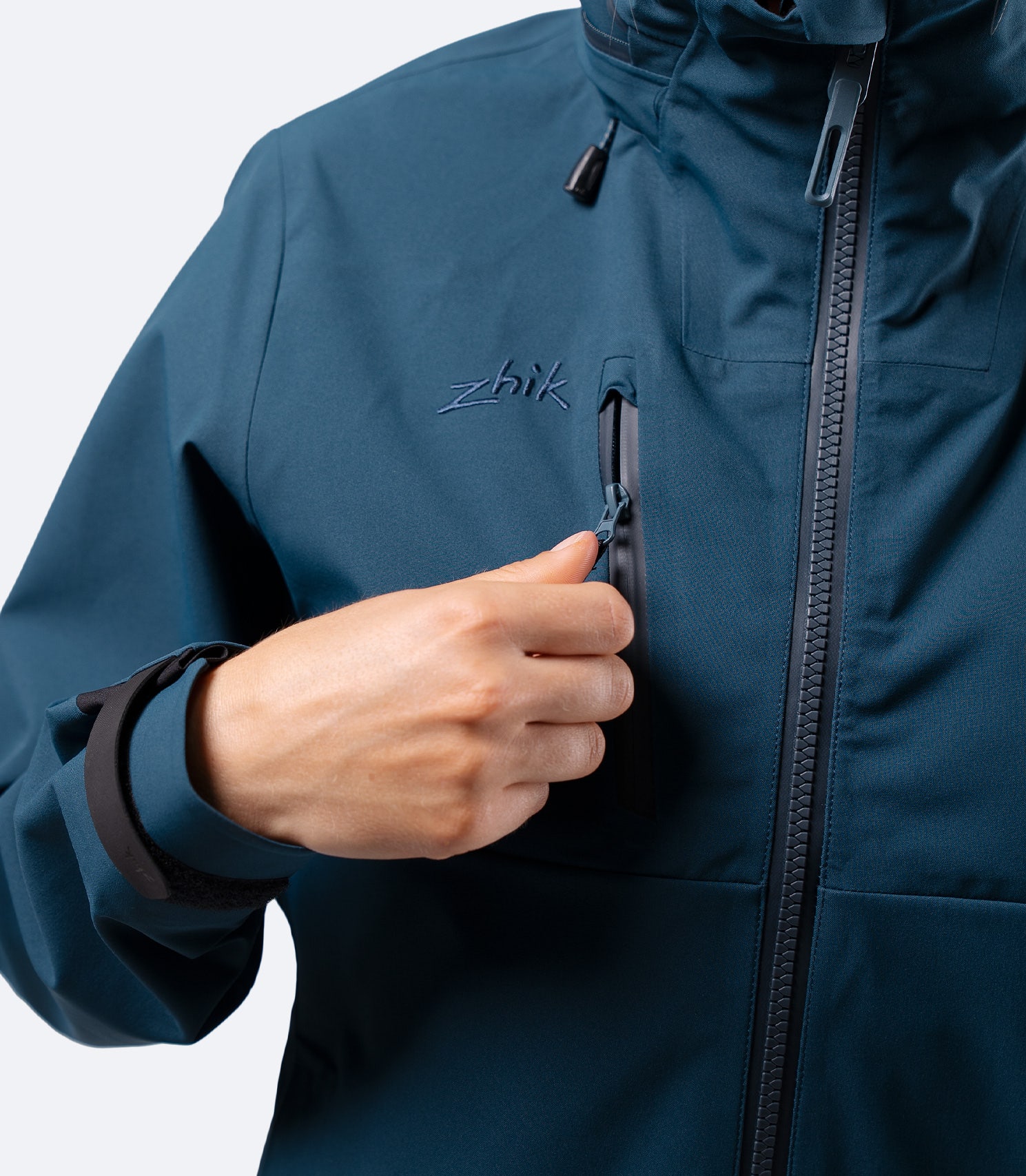 Chest pocket detail on Zhik Women's INS400 jacket in Deep Teal, with water resistant zipper and secure storage