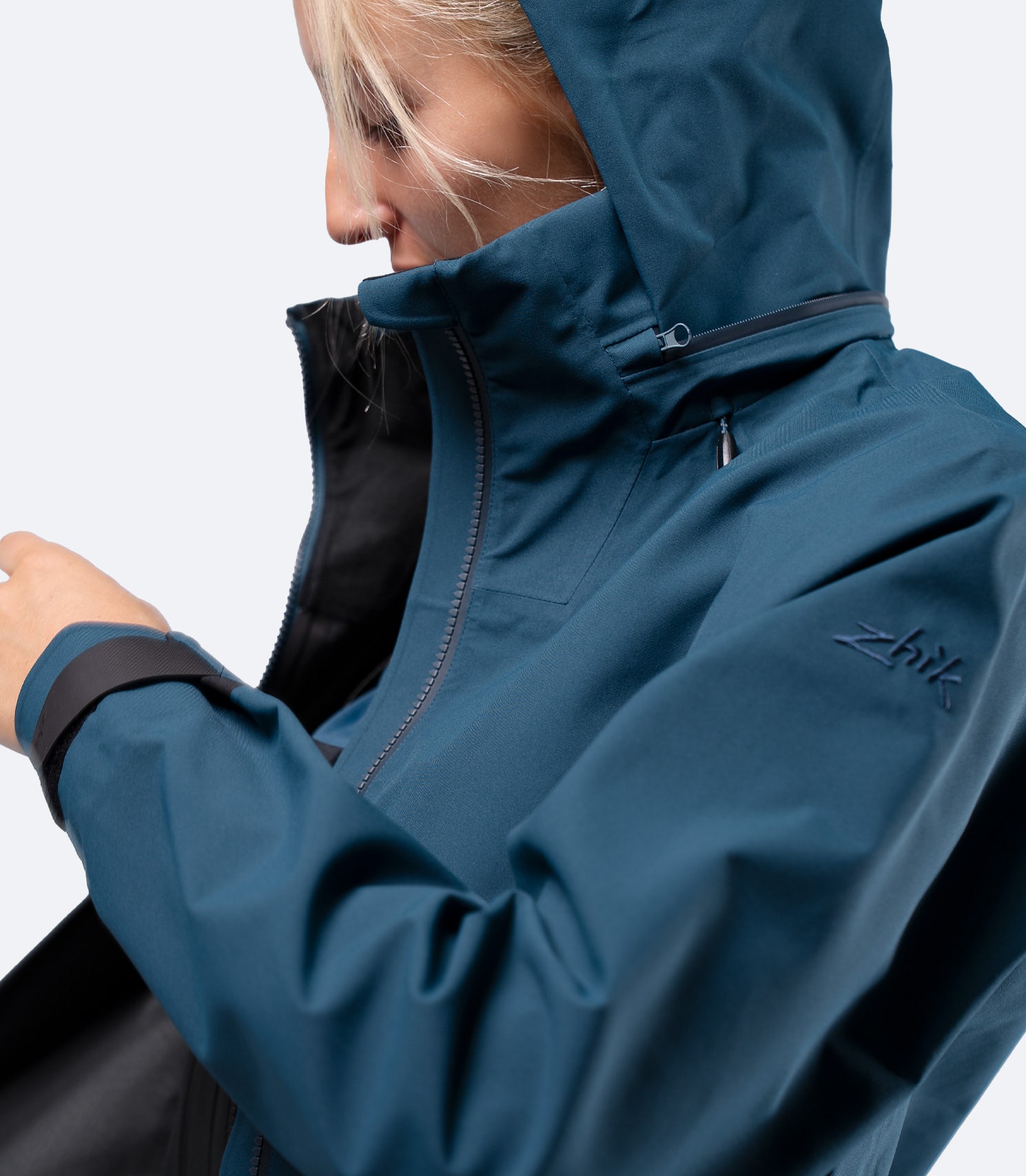 Shoulder detail of Zhik Women's INS400 jacket in Deep Teal, hood up, highlighting articulated arm design