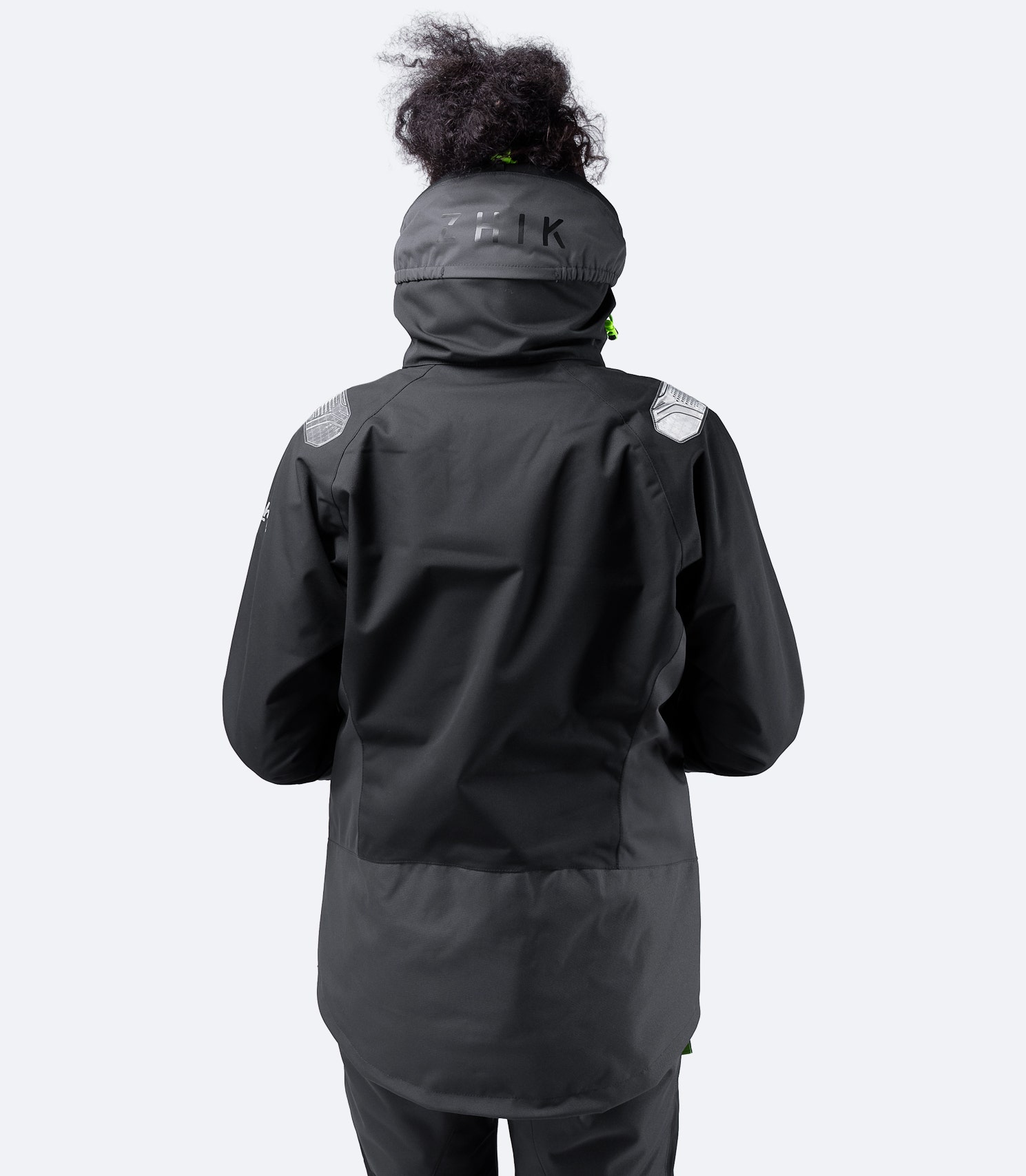 Rear view of Zhik Women's Black OFS700 Jacket showing reinforced rear panel and ergonomic fit for durability and comfort in offshore conditions.