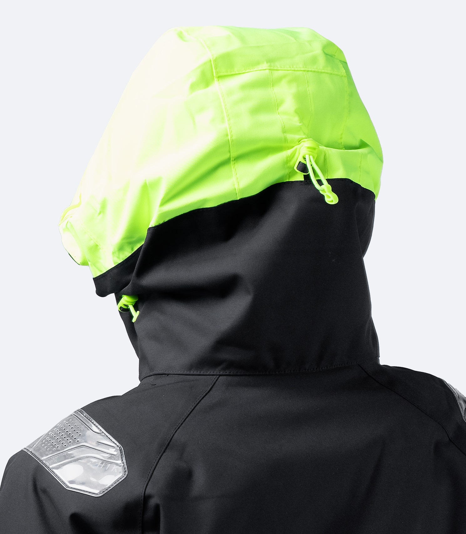 Rear view of Zhik Women's Black OFS700 Jacket with hood on, highlighting Reflexite reflectors for enhanced night-time visibility.