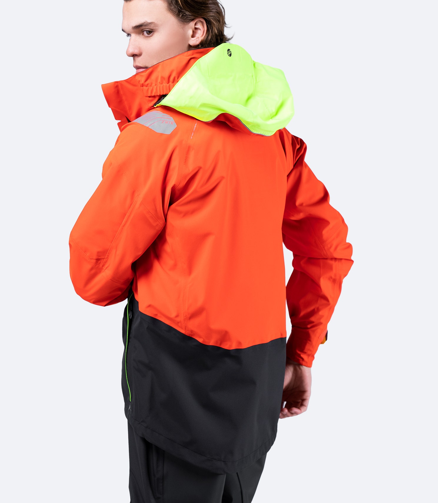 Back view of Zhik Men's CST500™ Jacket in Flame Red, showcasing the articulated arm panels and signature reinforced hang loop